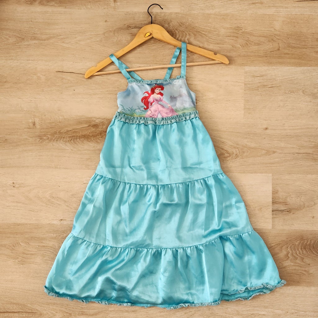 Turquoise Little Mermaid nightgown on hardwood floor.