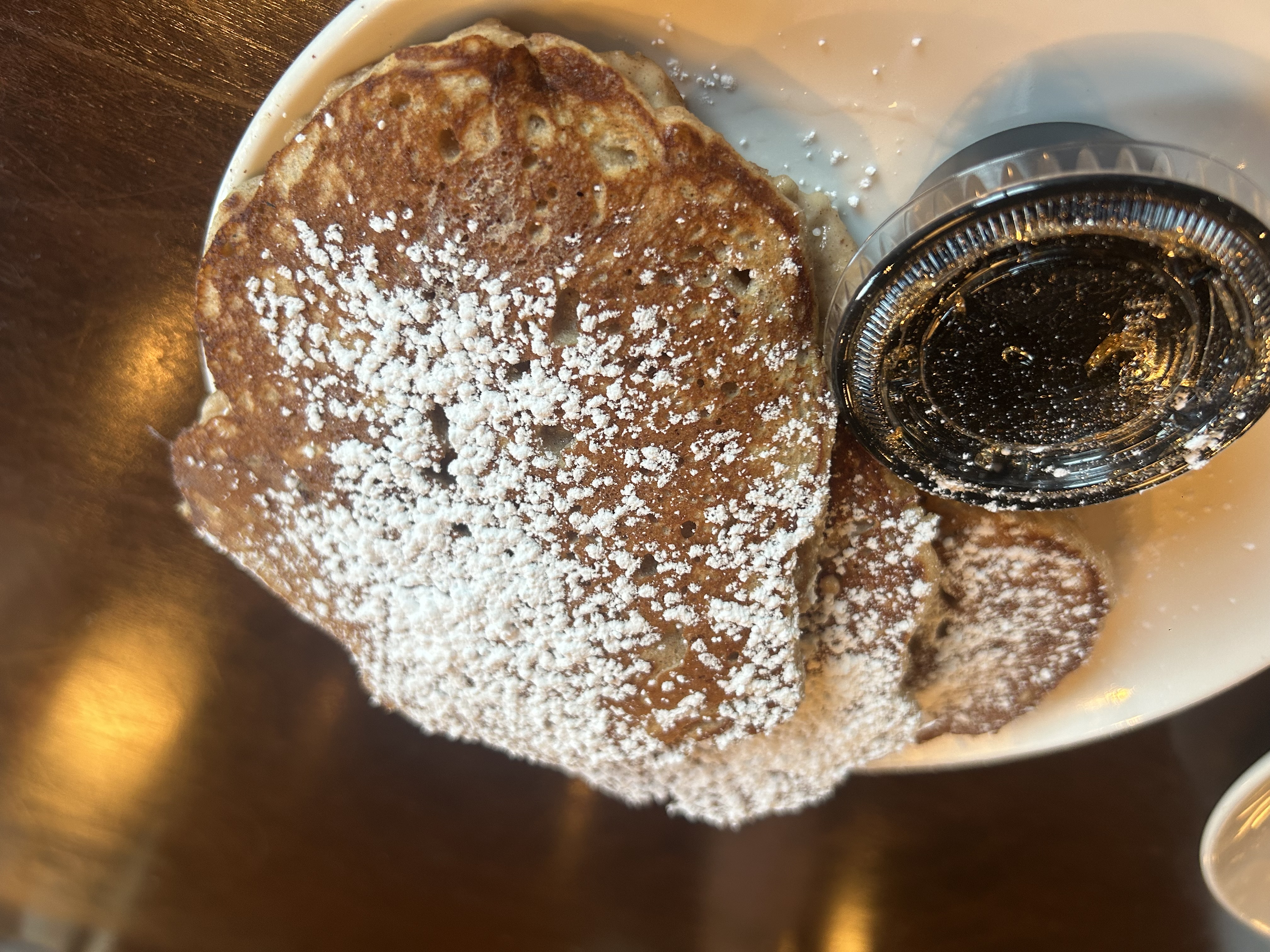 Top view of maple pancakes and maple syrup