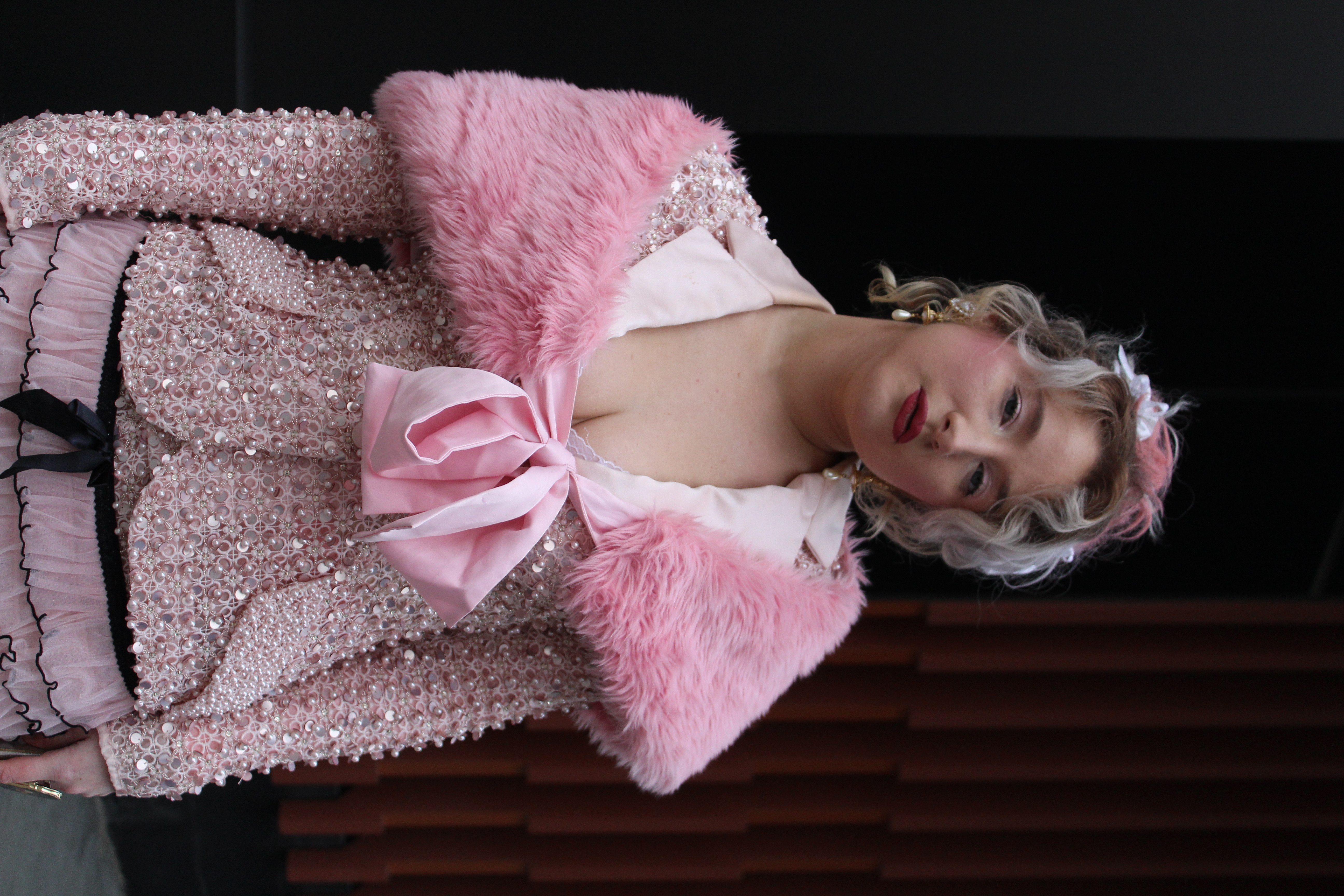 Woman in pink clothing shows off her NYFW outfit