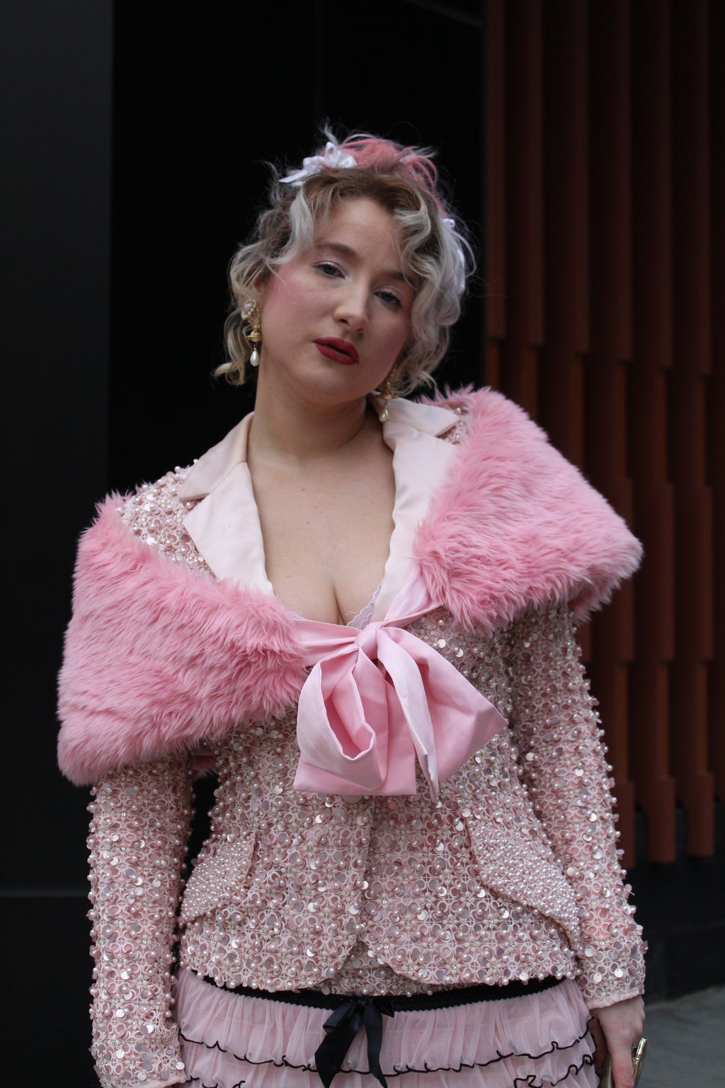 Woman in pink clothing shows off her NYFW outfit