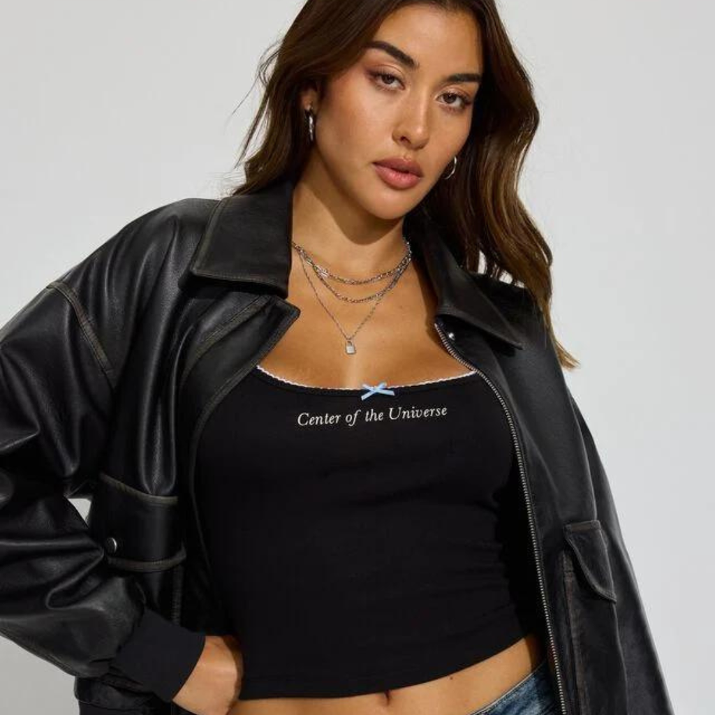 woman wearing a graphic cami tank and leather jacket