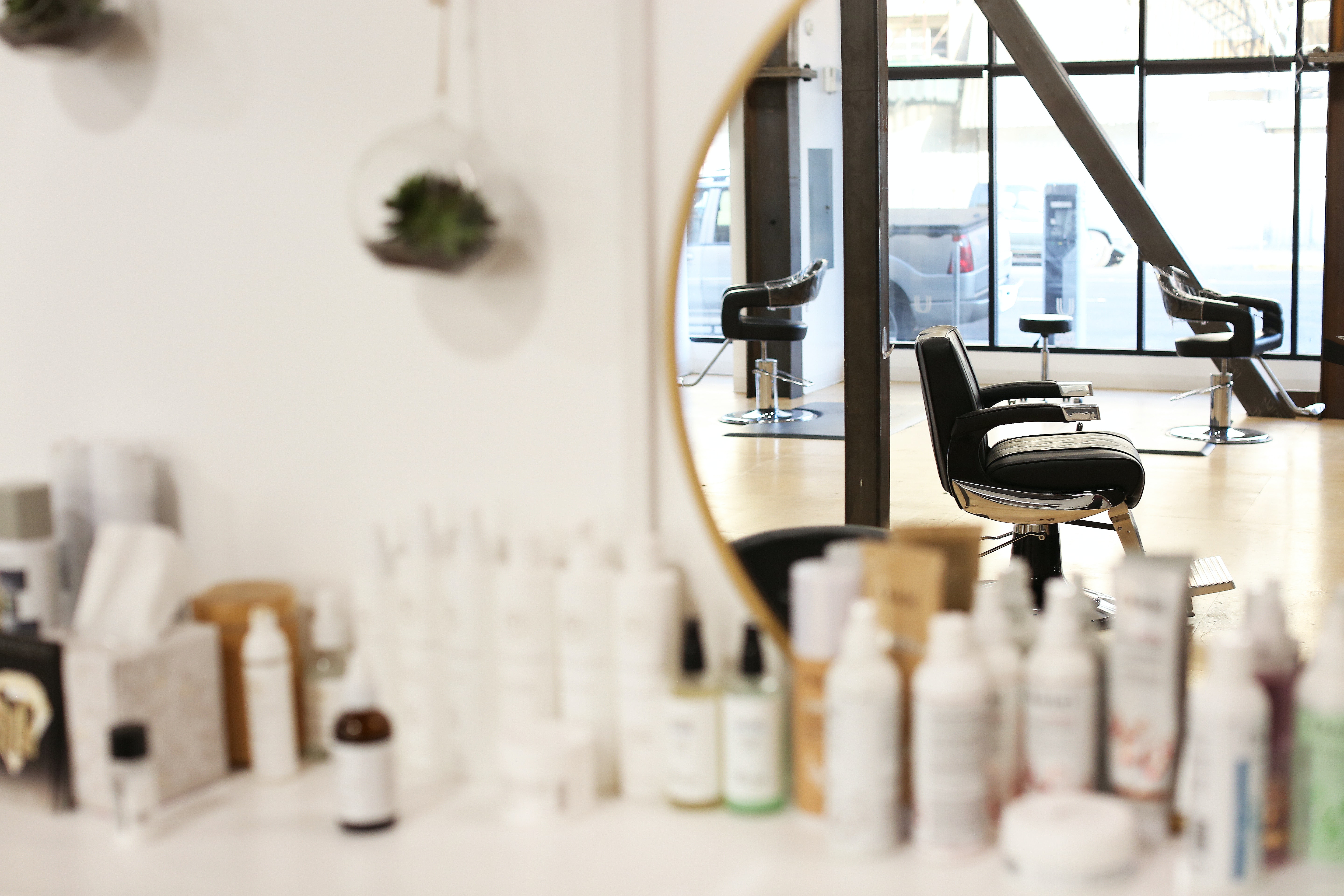 Hair salon in a mirror with hair products on the counter