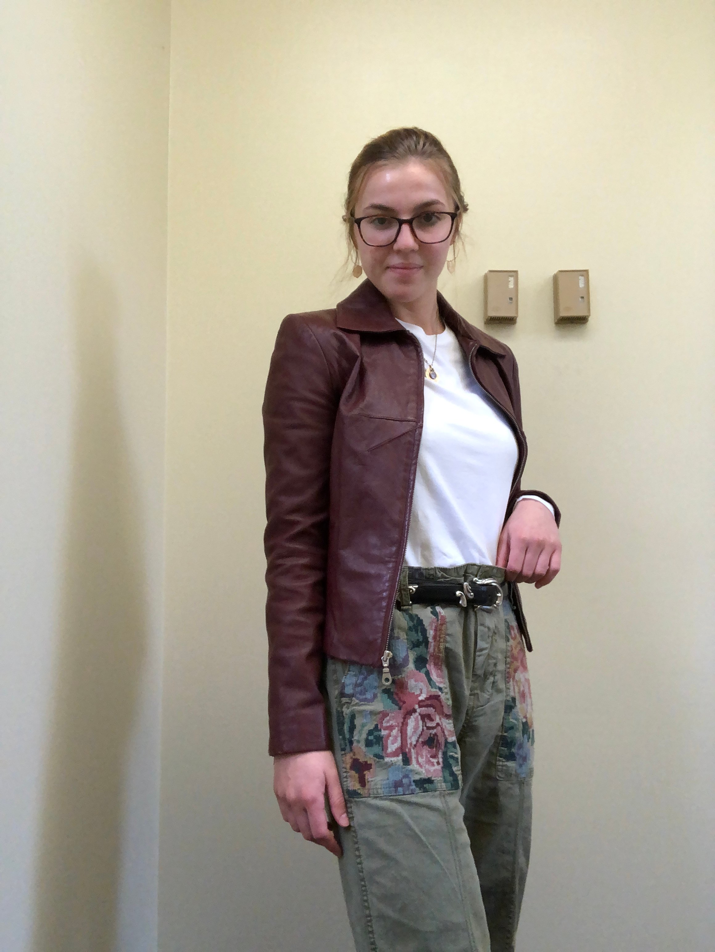 Girl in leather jacket and green pants