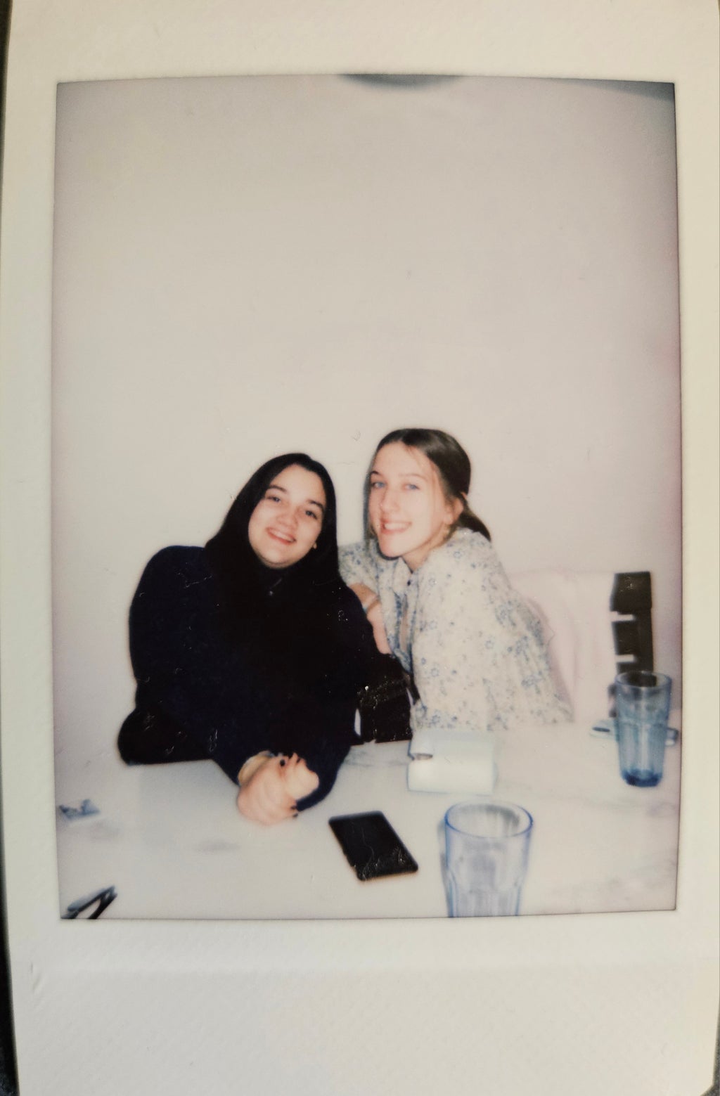 photo of a polaroid picture of two girls