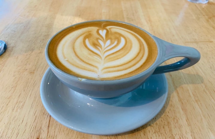 A gorgeous hot latte in a blue mug