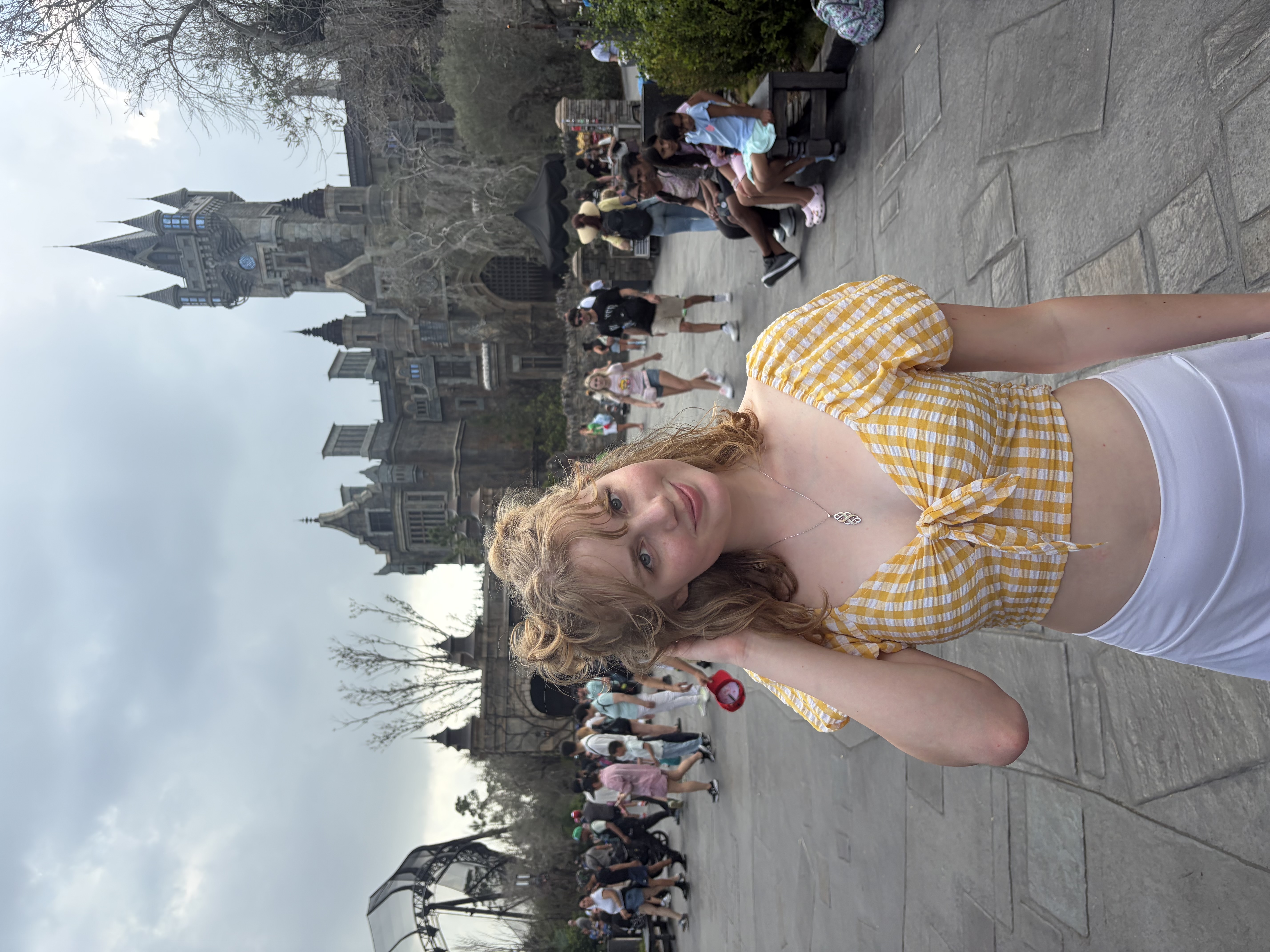 A girl standing in front of a castle