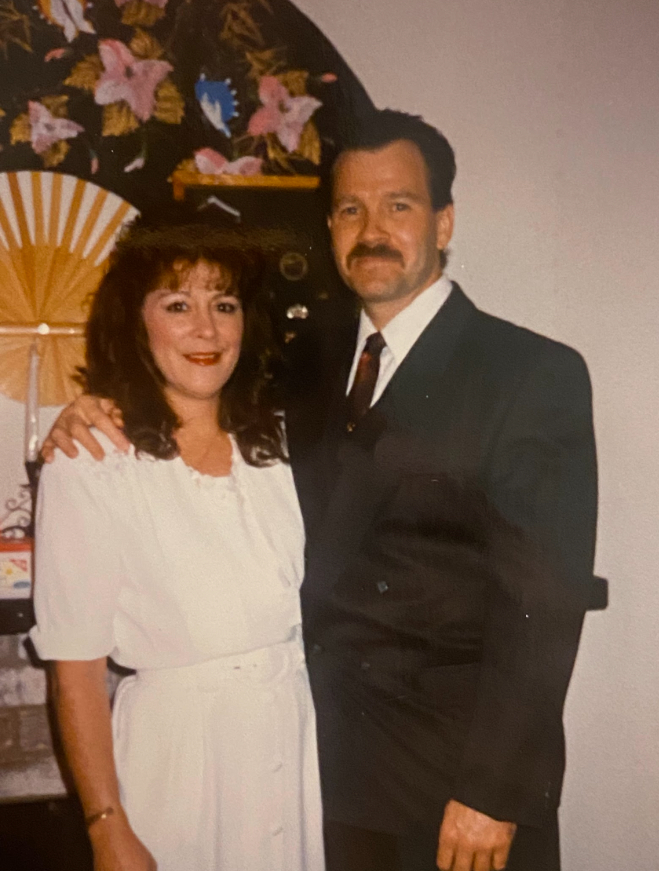 husband wearing a suit and wife wearing a white gown on their wedding day