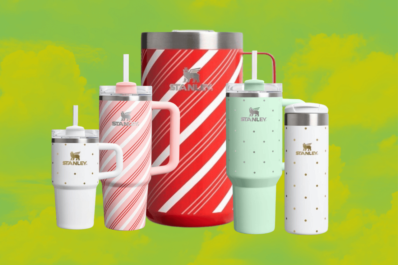 5 stanley tumblers on a green background