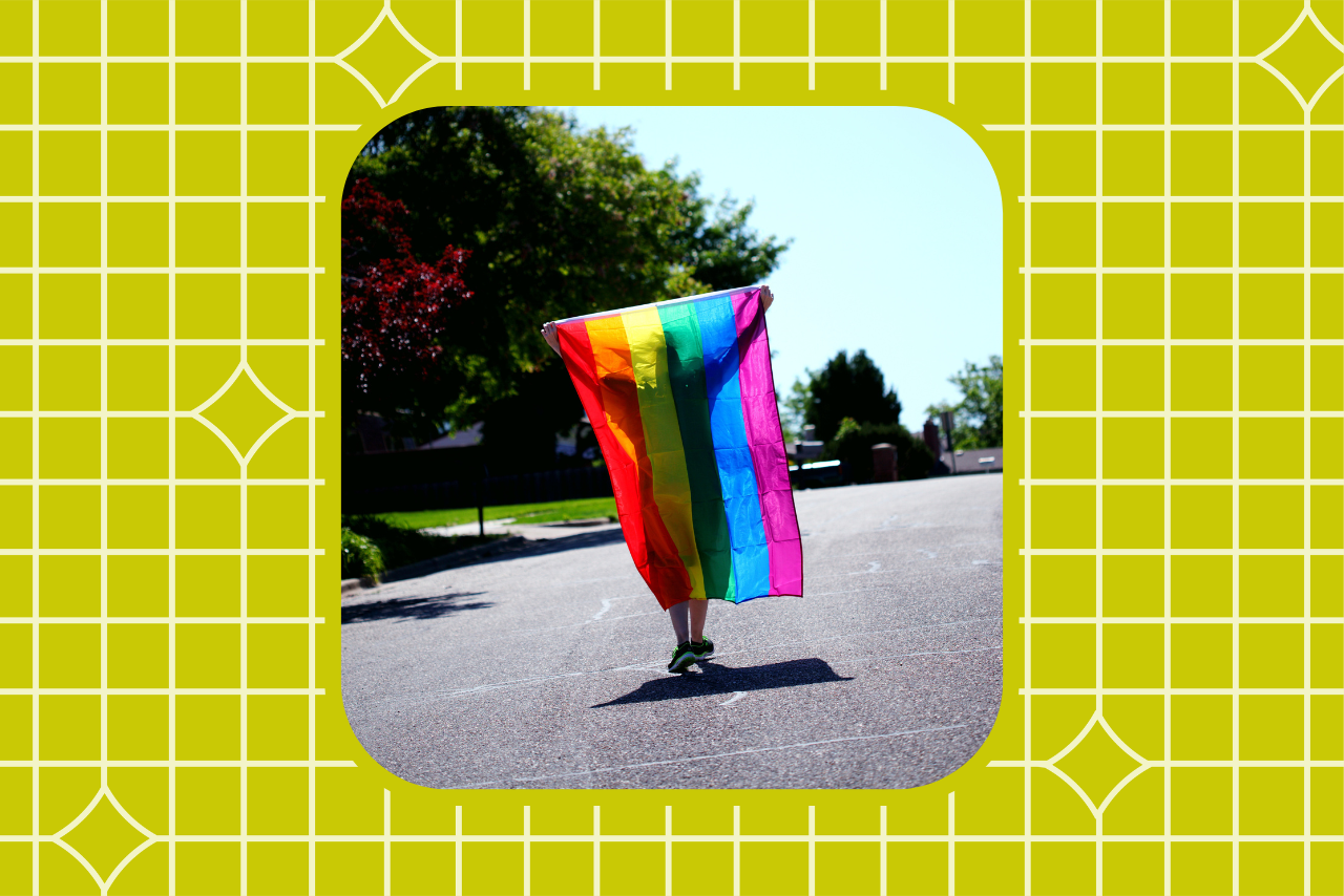 Person holding LGBTQ+flag.