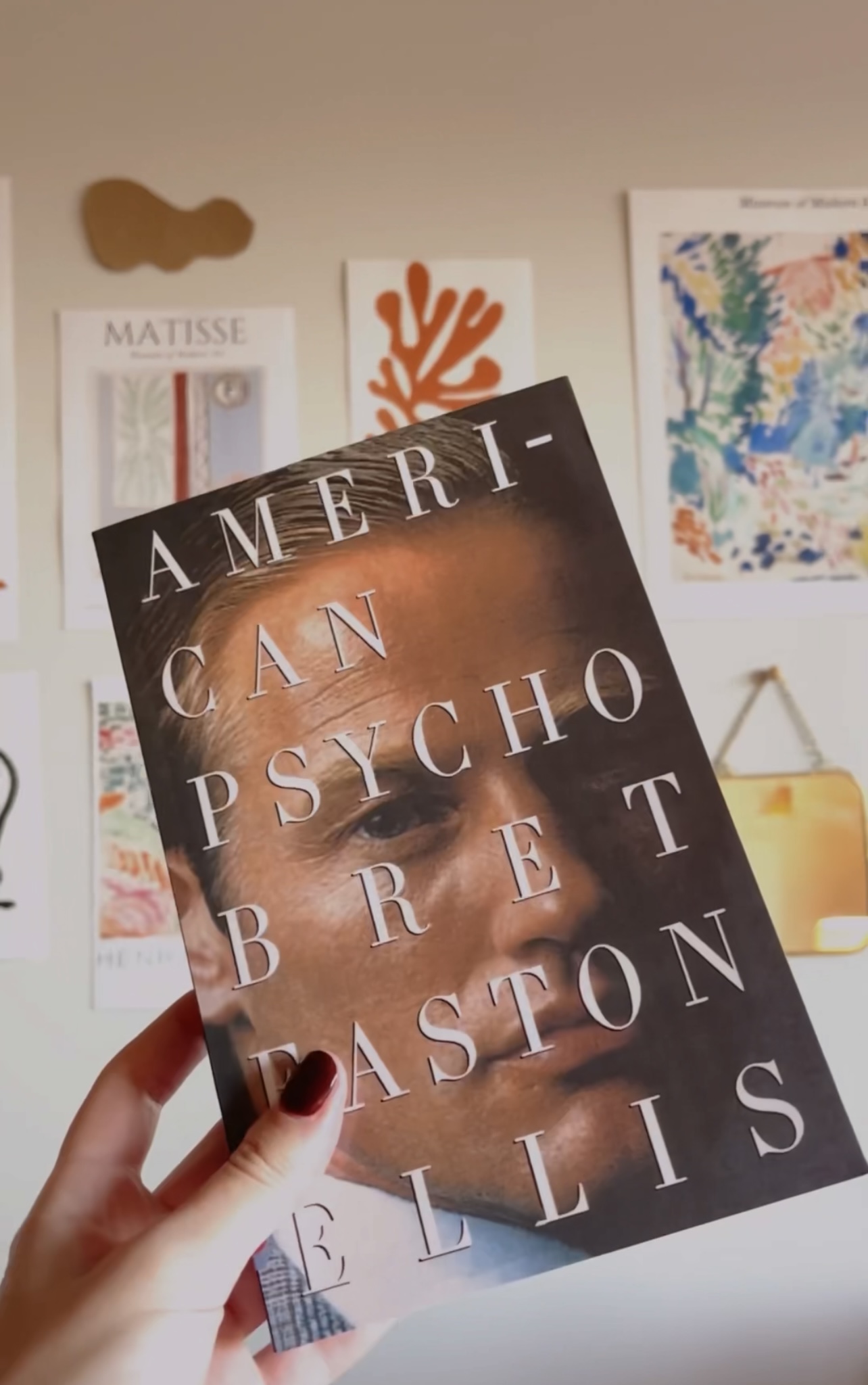 Photo of hand holding a book. American psycho.