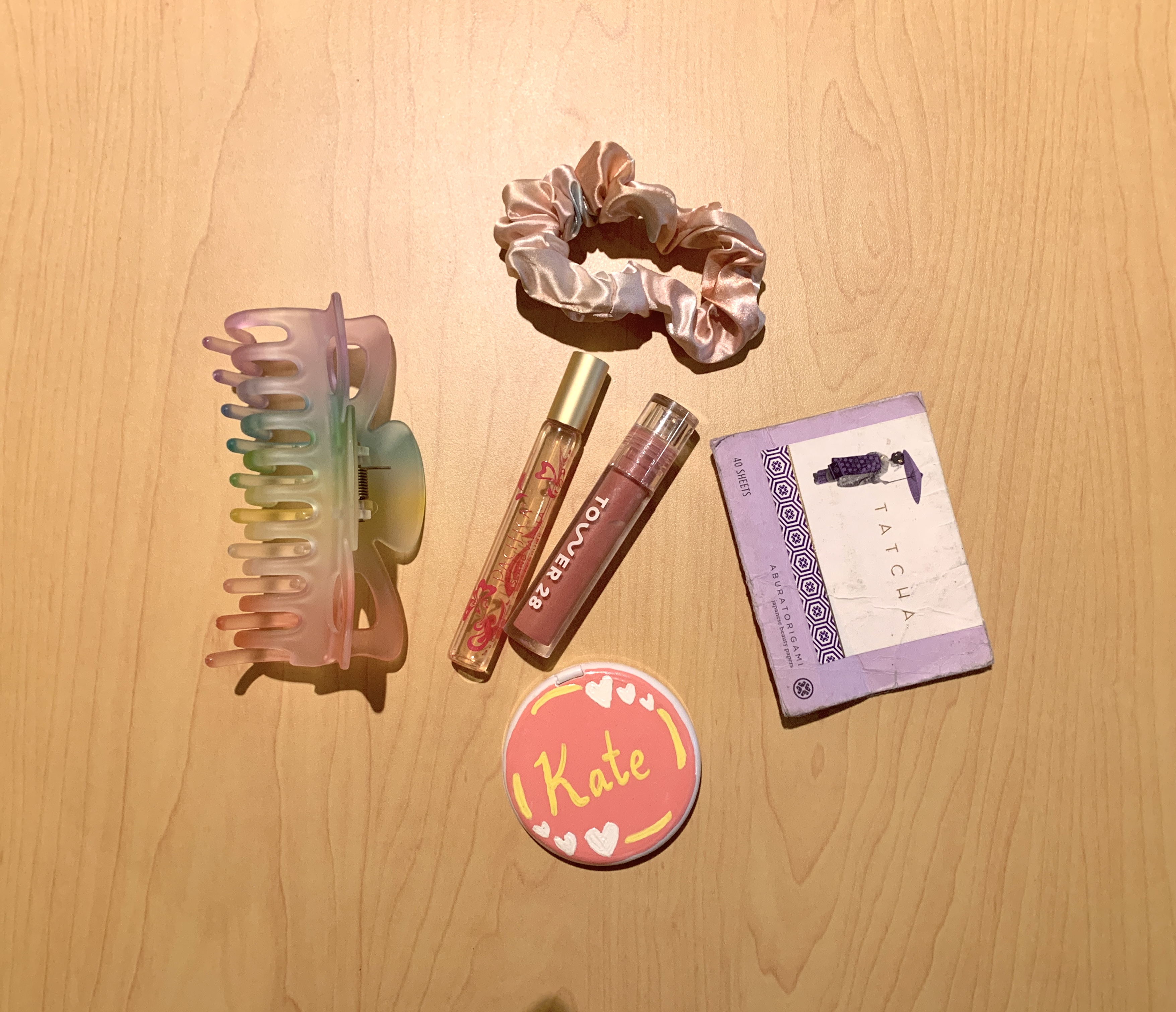 Beauty items including lip gloss and a claw clip.