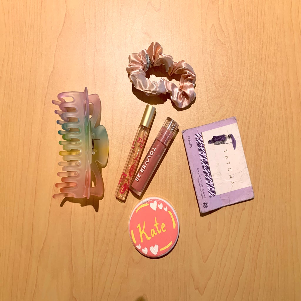 Beauty items including lip gloss and a claw clip.