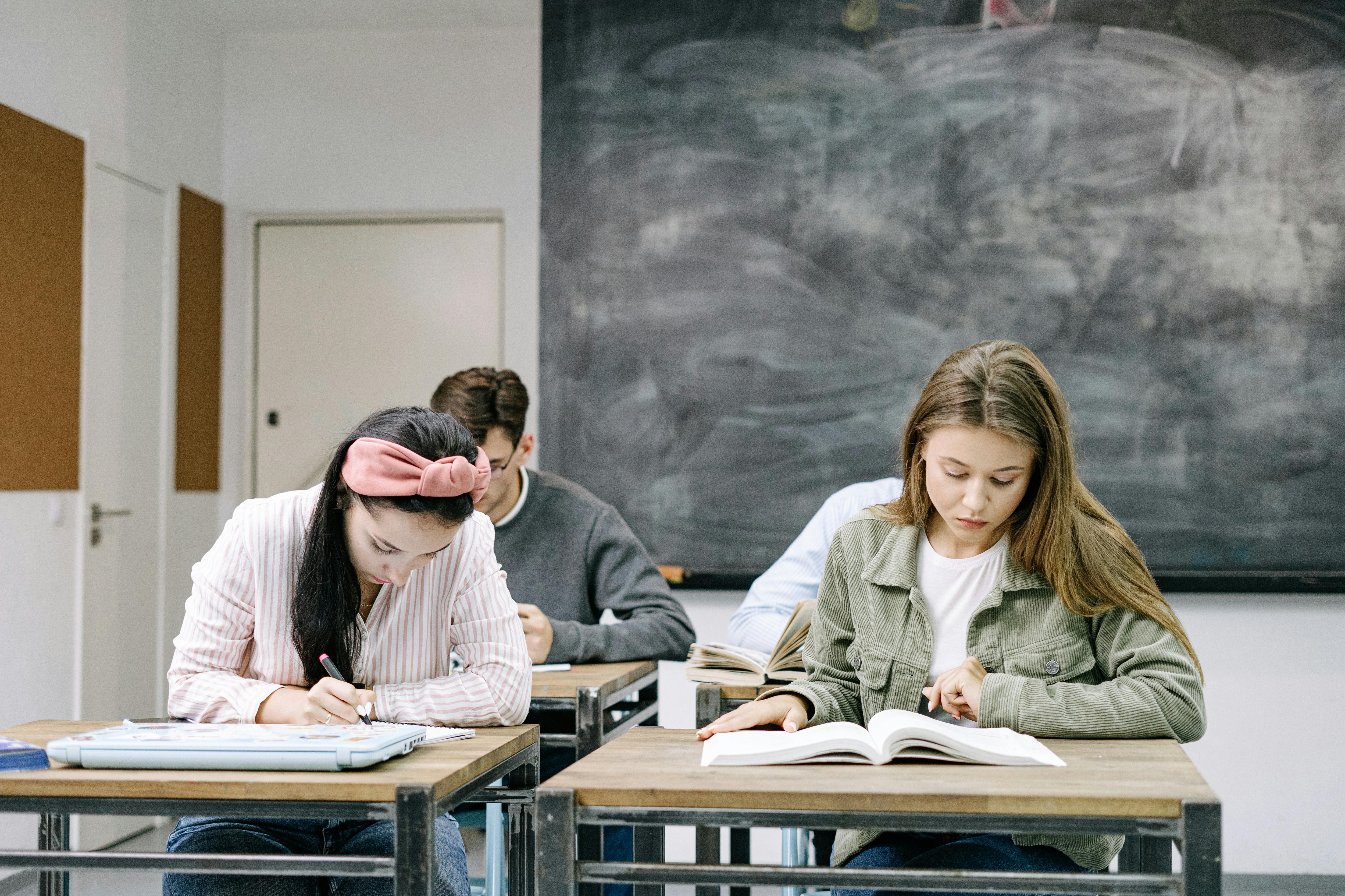 High school students sitting in a classroom with textbooks