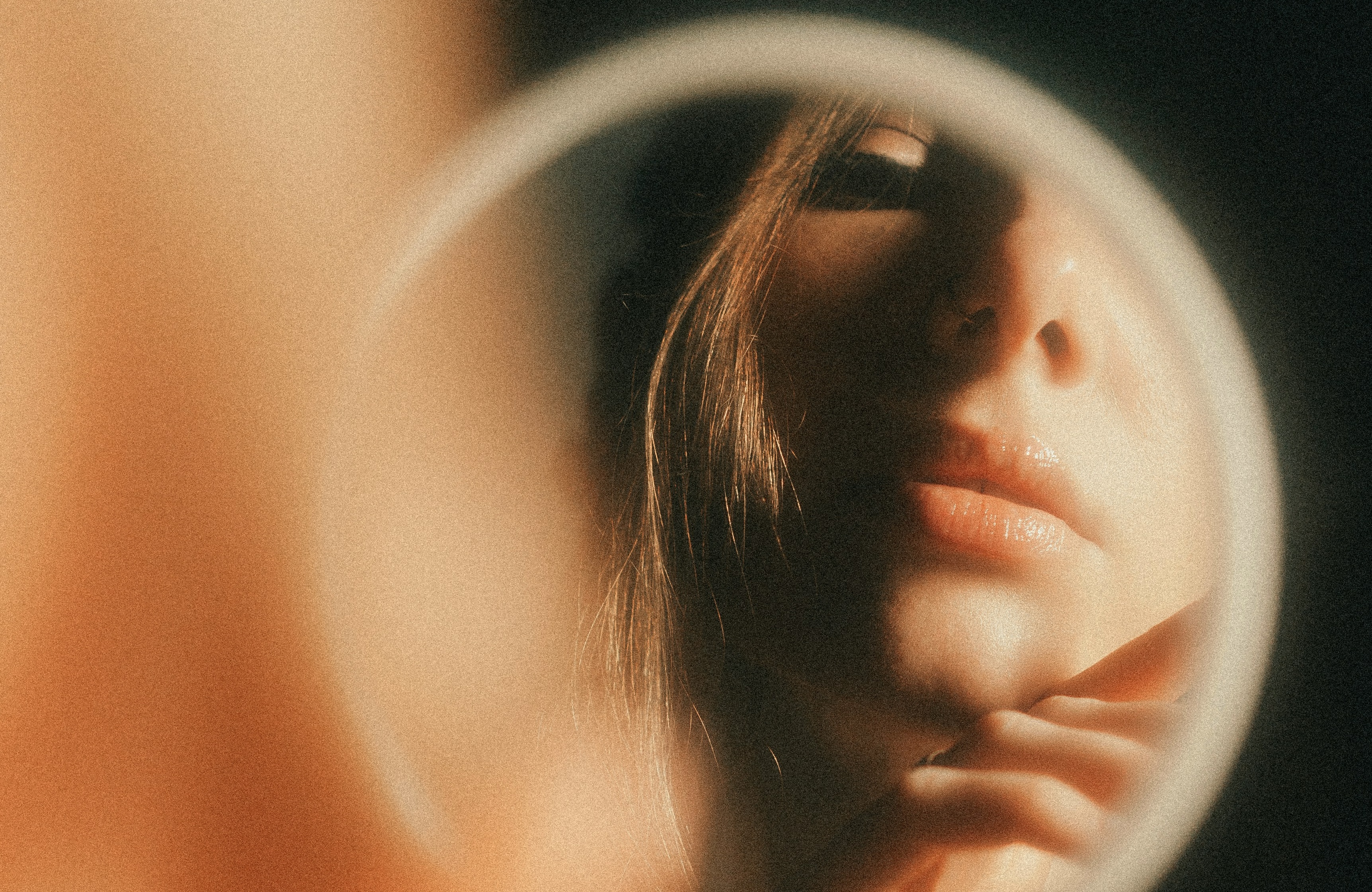 woman’s reflection in handheld mirror