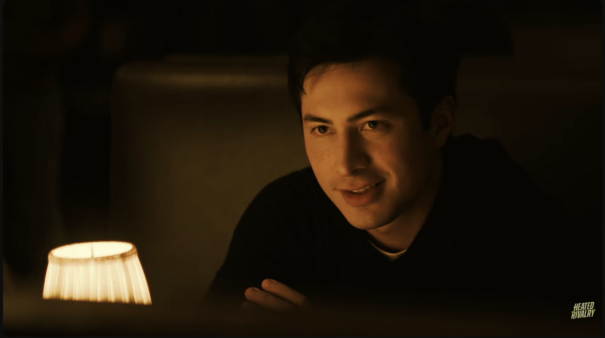 Man sitting at a dimly lit restaurant table