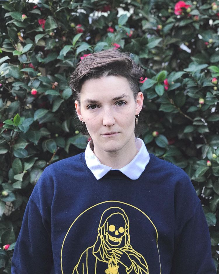 person in front of flower bush