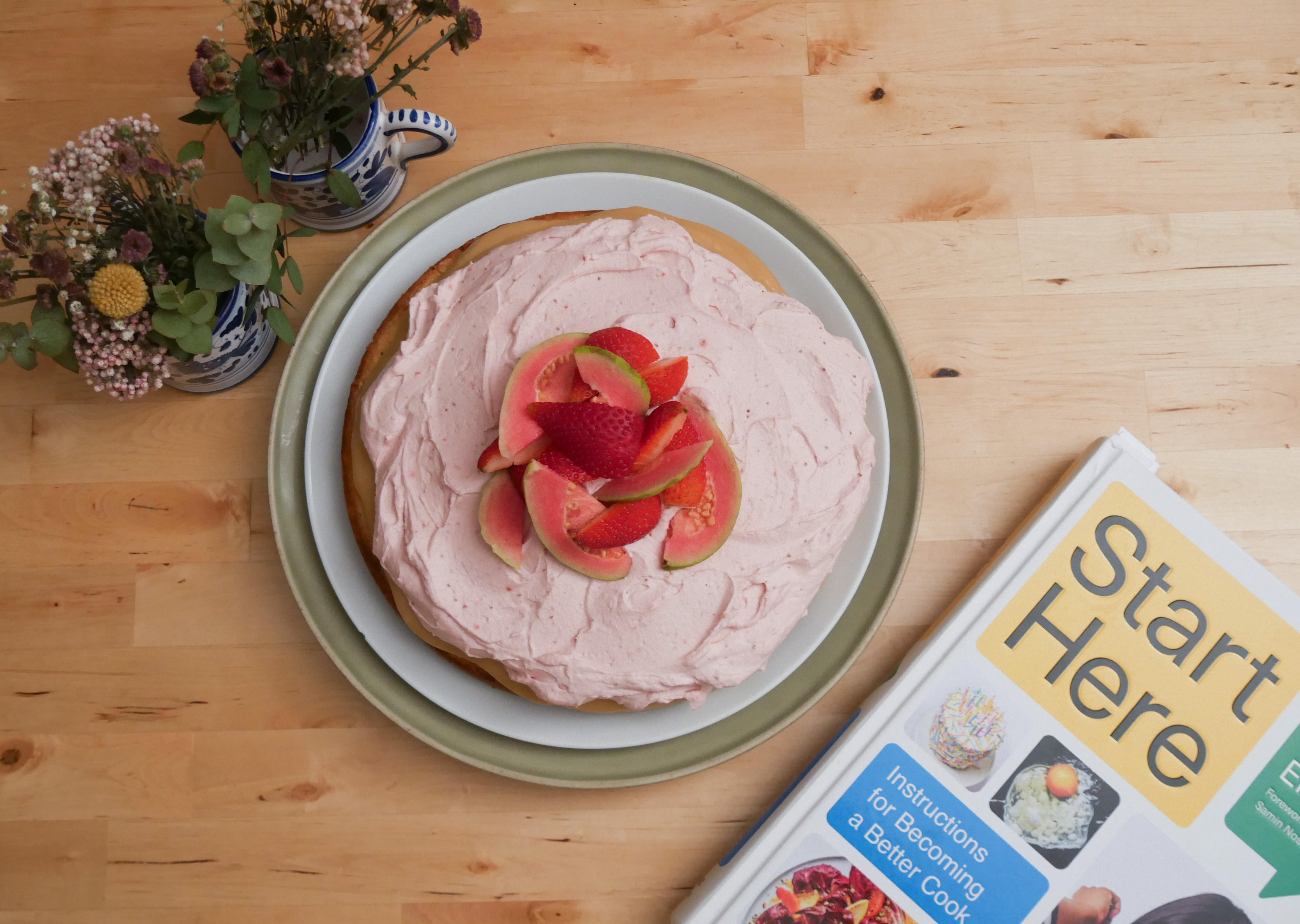 Cake, book and flowers in an overhead shot