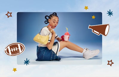 woman sitting on the ground holding a yellow purse and a slushie