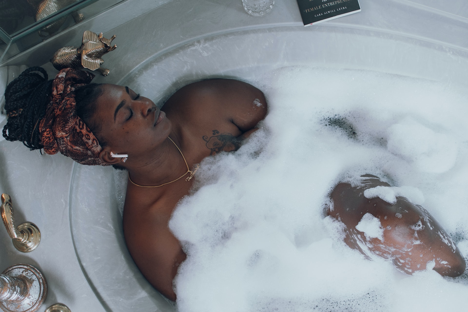 woman in bubble bath relaxing eyes closed