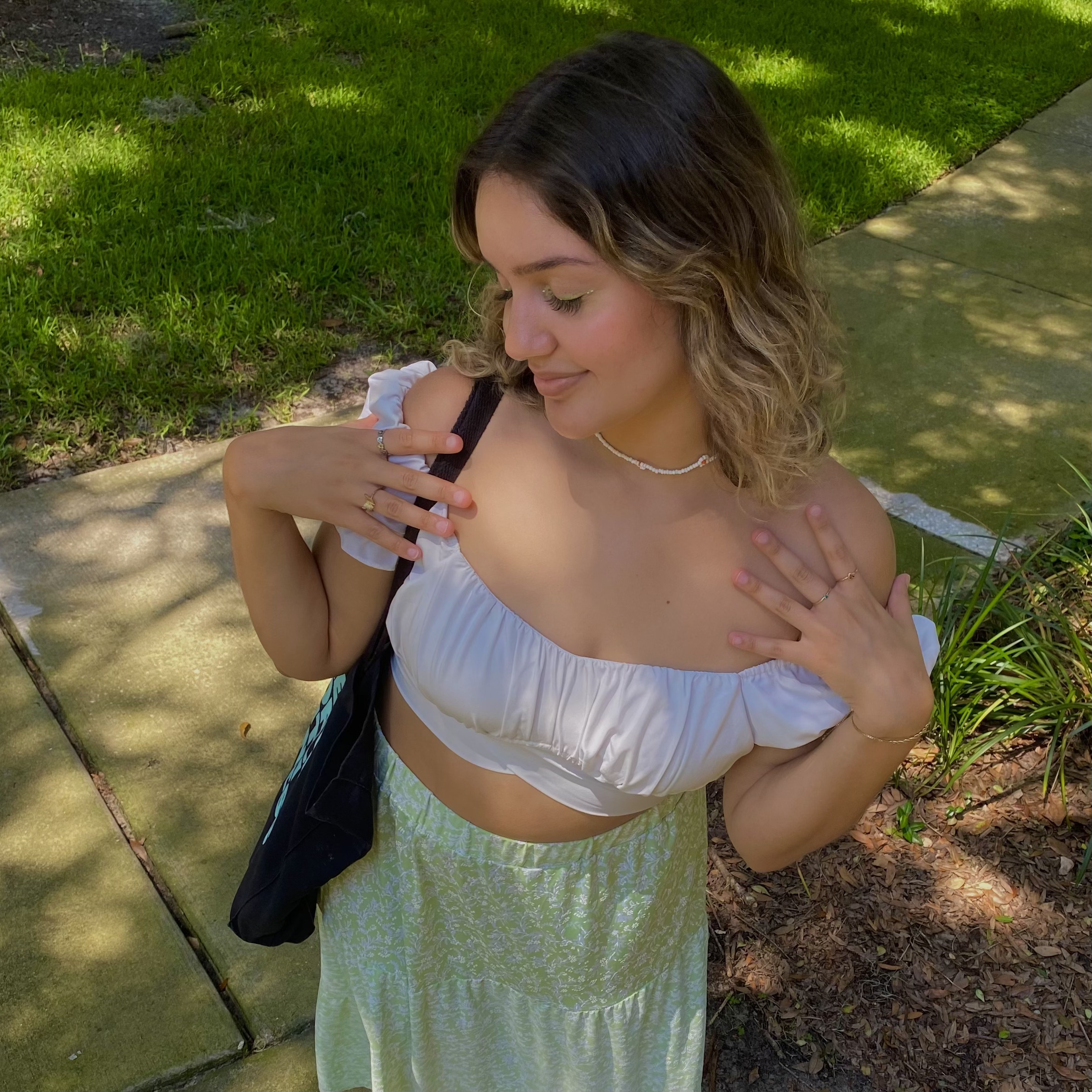 Picture of Isa Sodre in a white top and green skirt