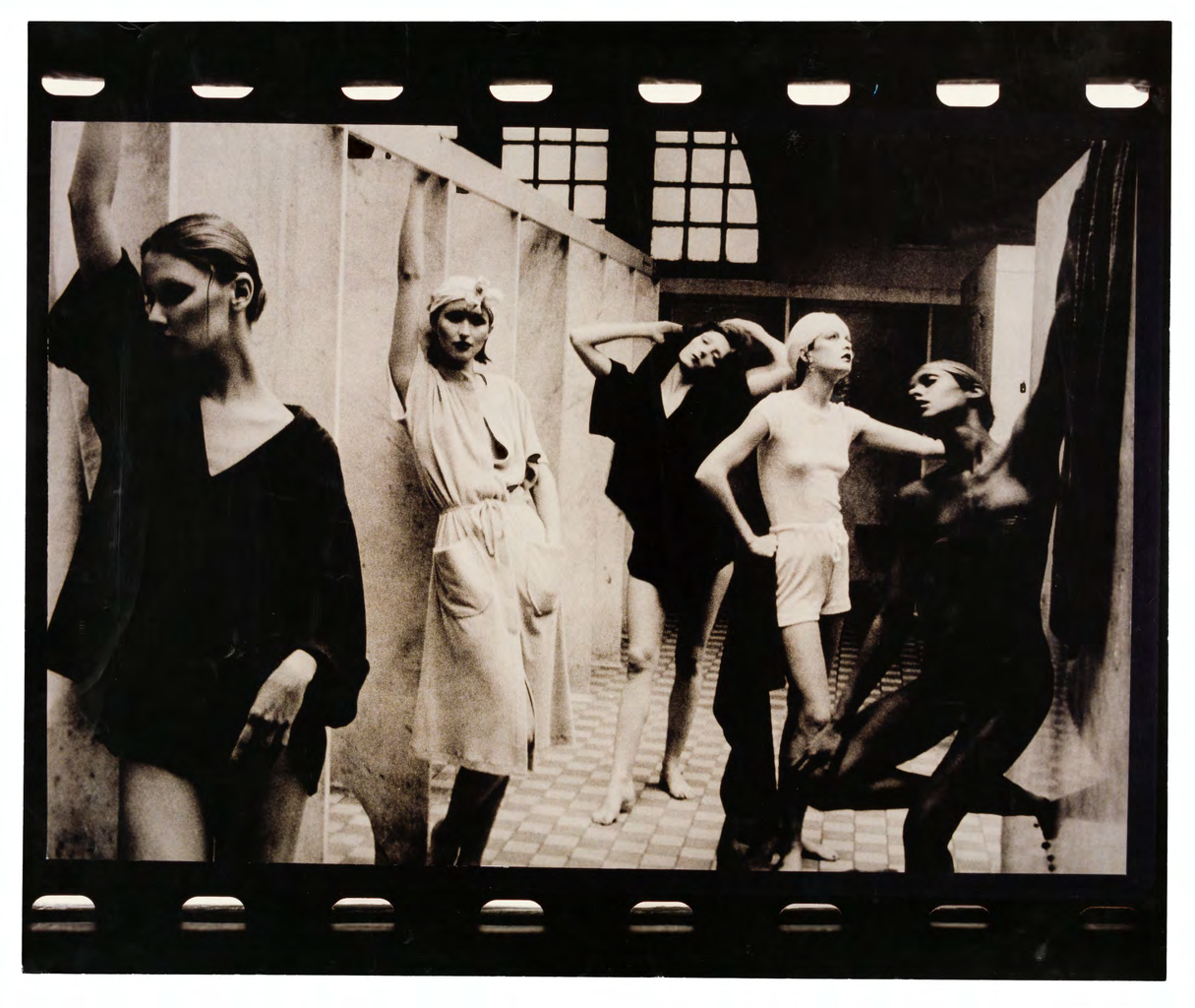 A black and white chromogenic photograph of five standing women from Deborah Turbeville\'s \'Otherworldly\' collection from the 1975 vogue catalogue.