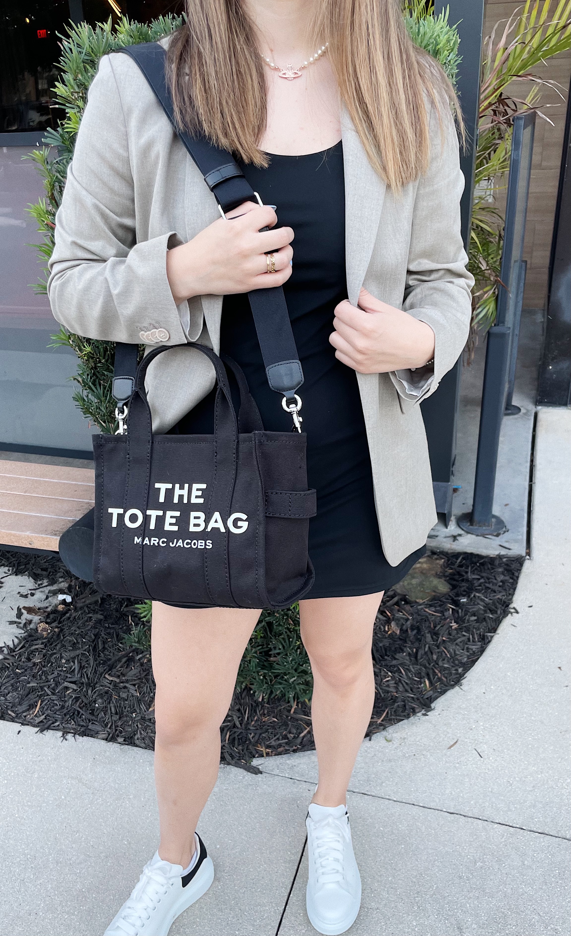 girl wearing black dress and tan blazer