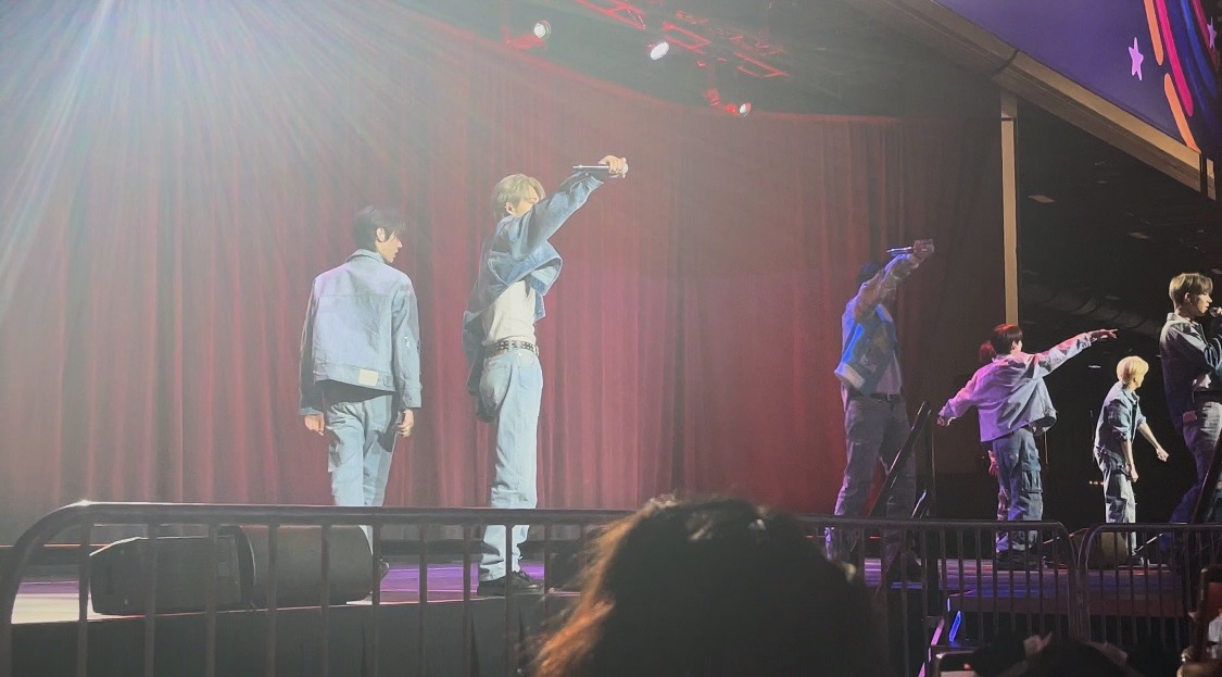 k-pop group on stage singing