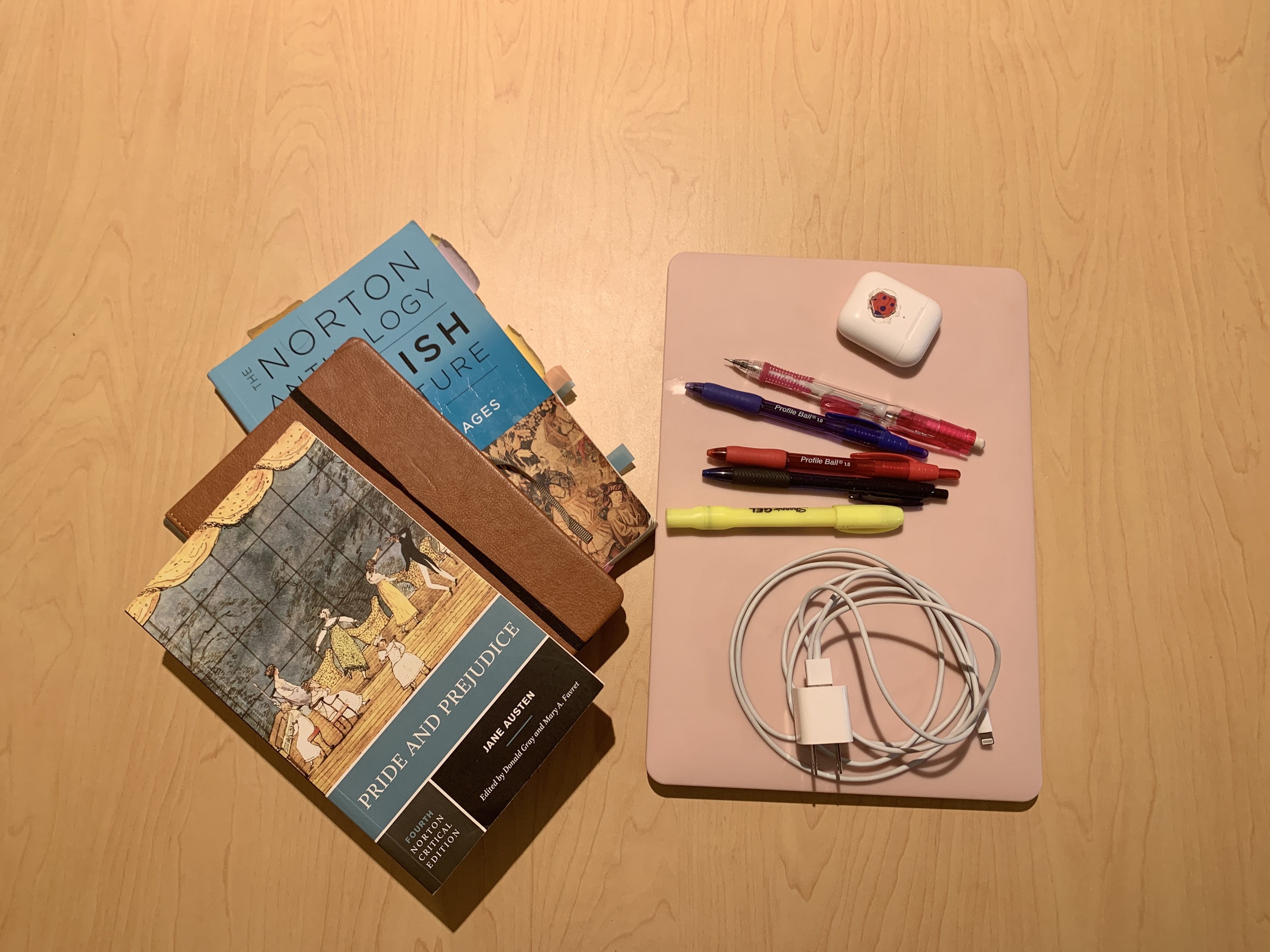 School supplies including notebooks, a computer and pens.