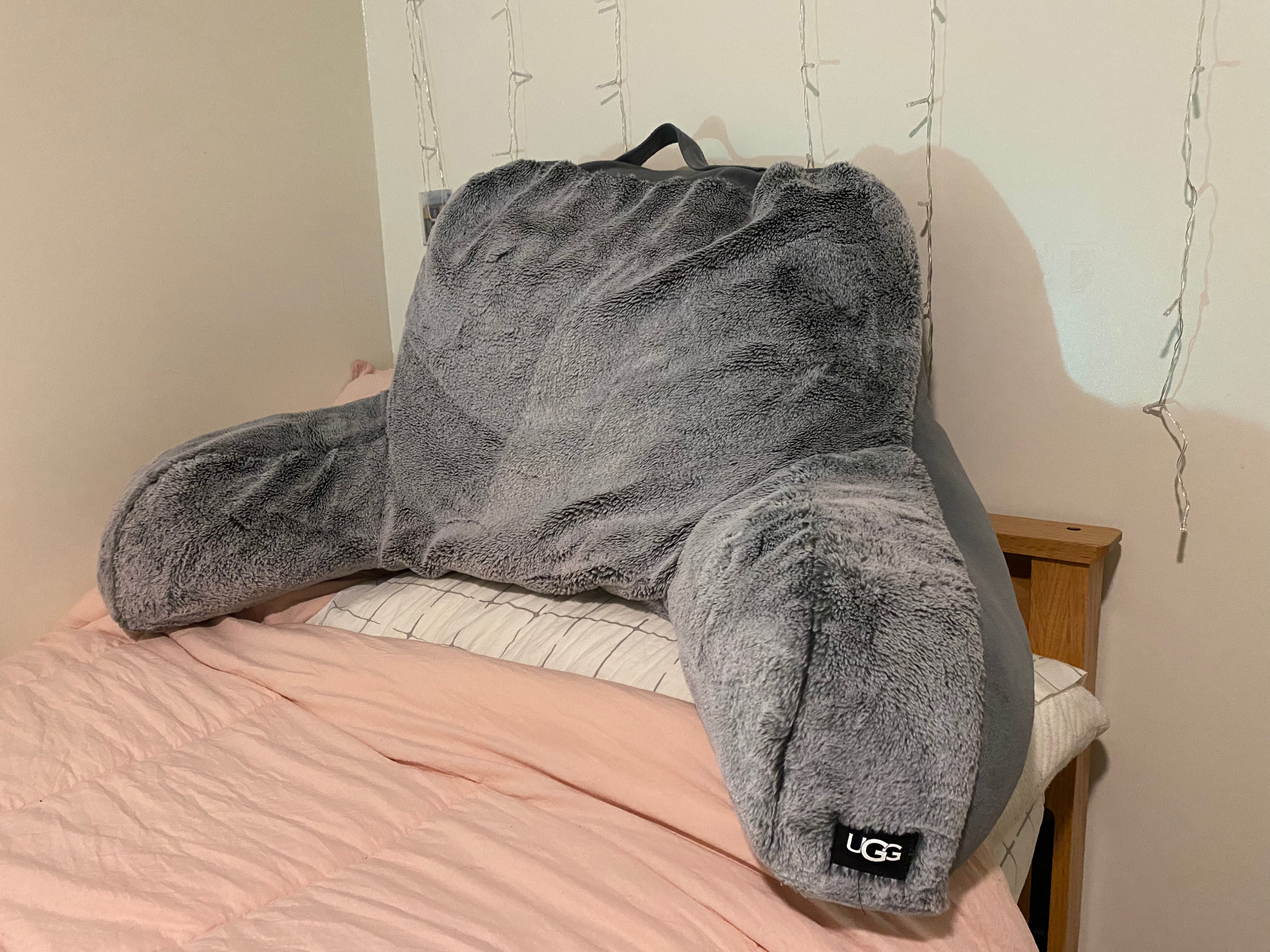 A back pillow on top of a bed