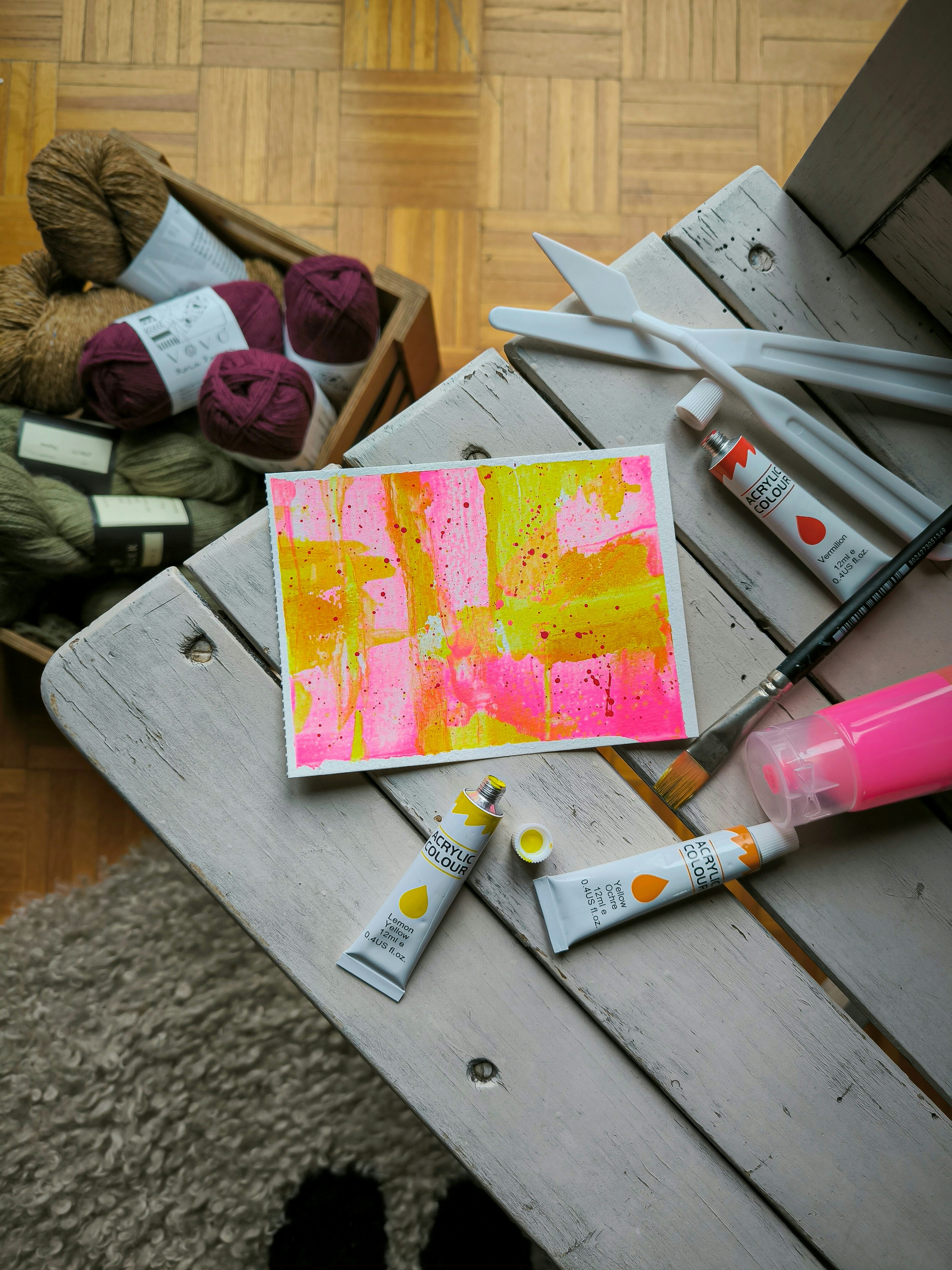 a table with art supplies around and on it