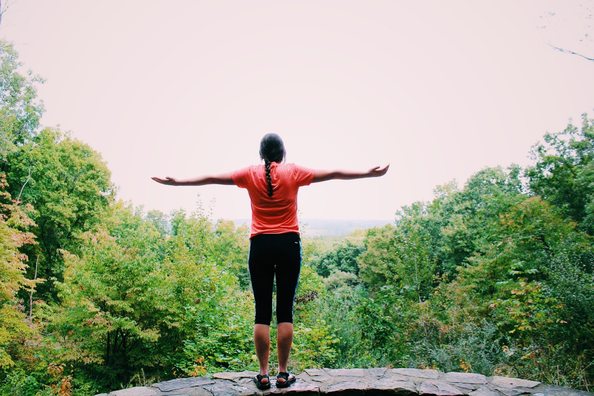 girl with arms open in nature