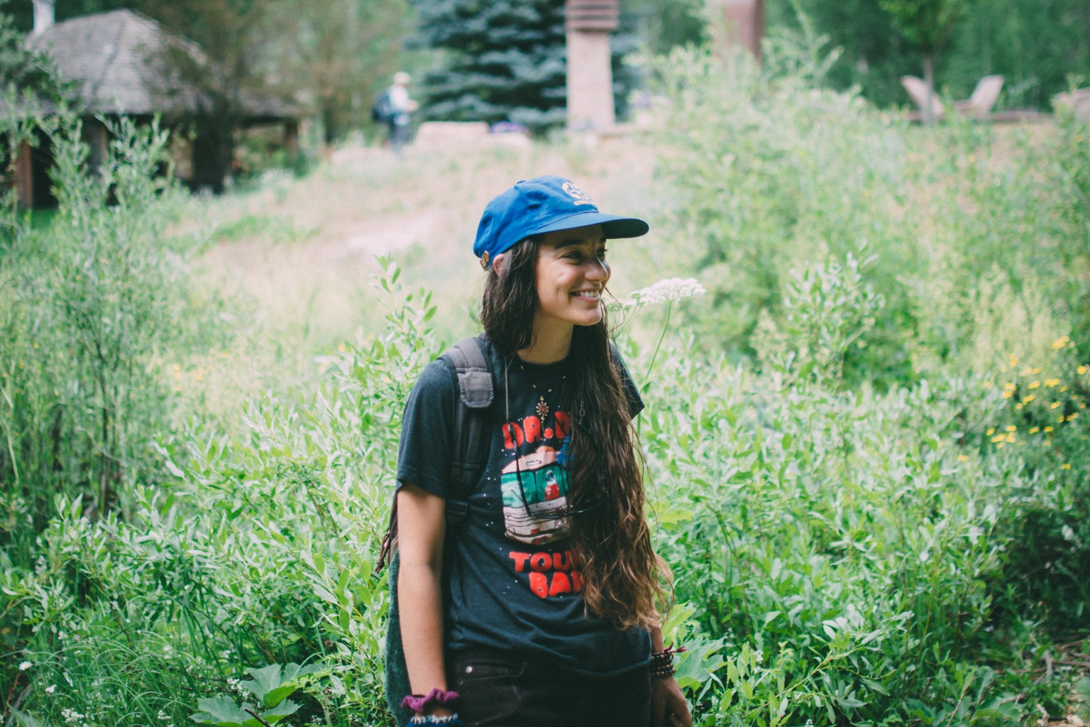 girl smile happy nature garden packpack hat tshirt
