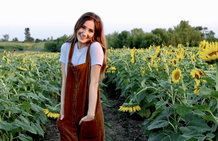 brunette happy girl sunflower field dress hands in pockets