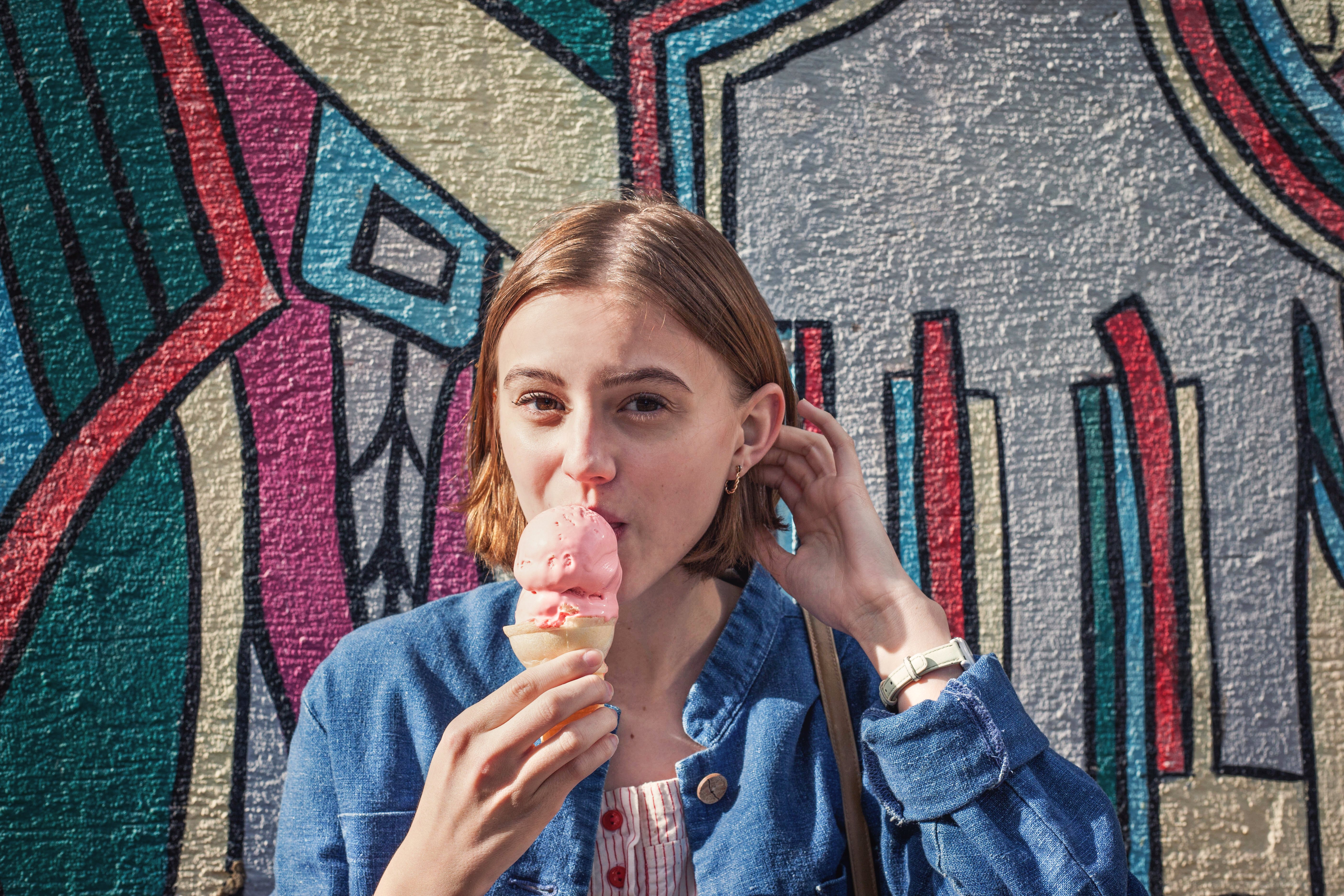 kristen bryant girl in front of colorful mural eating ice cream?width=698&height=466&fit=crop&auto=webp&dpr=4