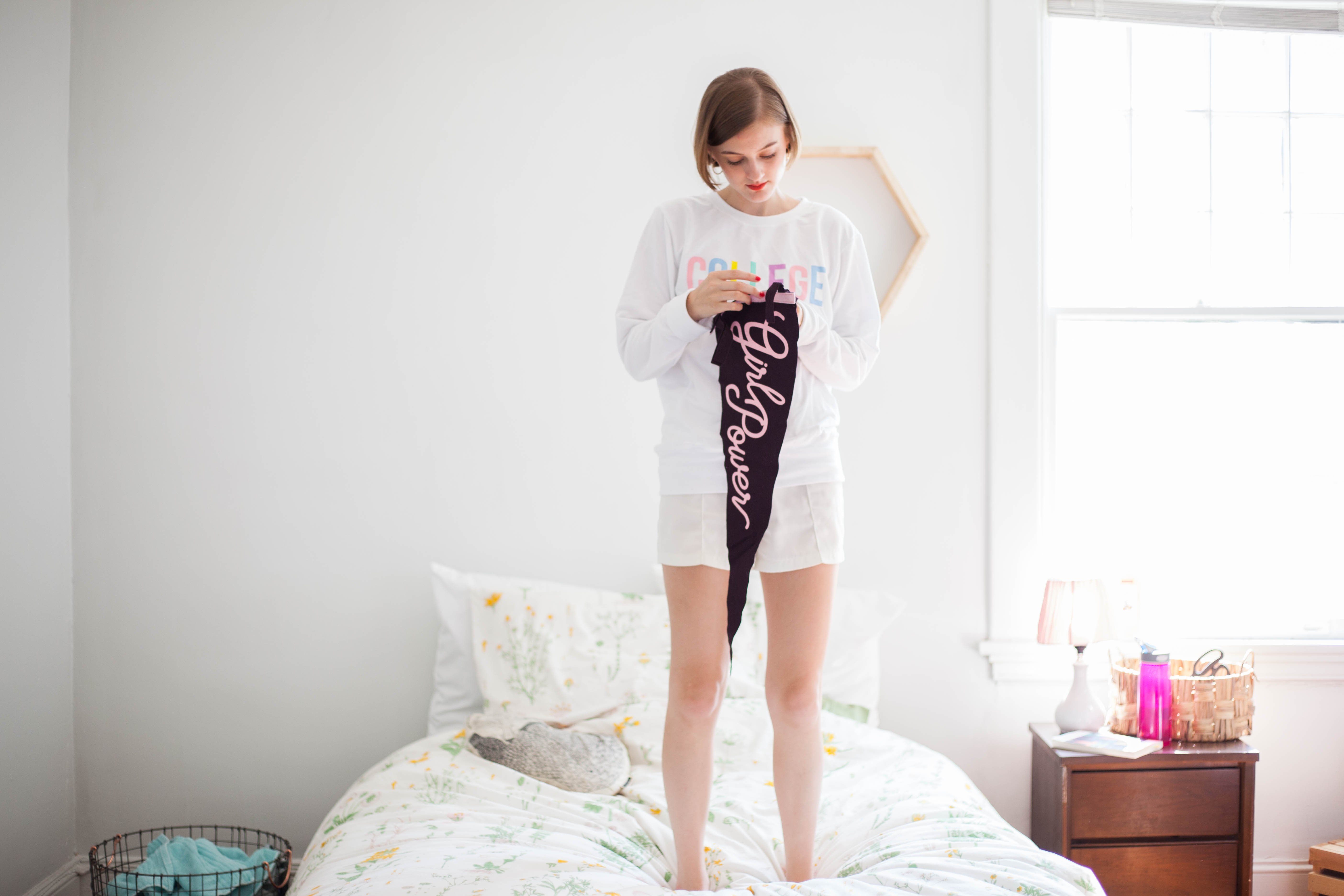 girl thinking with college sweatshirt and girl power