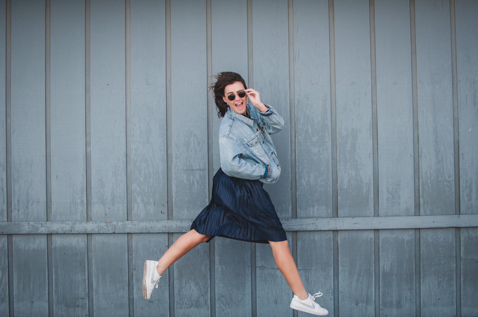 girl with jean jacket and skirt jumping 2