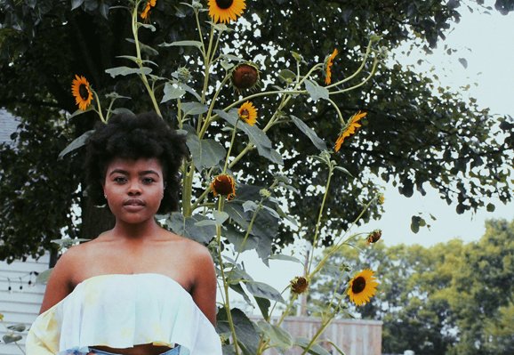 Amelia Kramer-Girl In Front Of Sunflowers