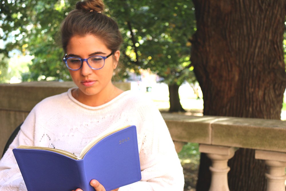 the lala girl reading a book outside?width=698&height=466&fit=crop&auto=webp&dpr=4