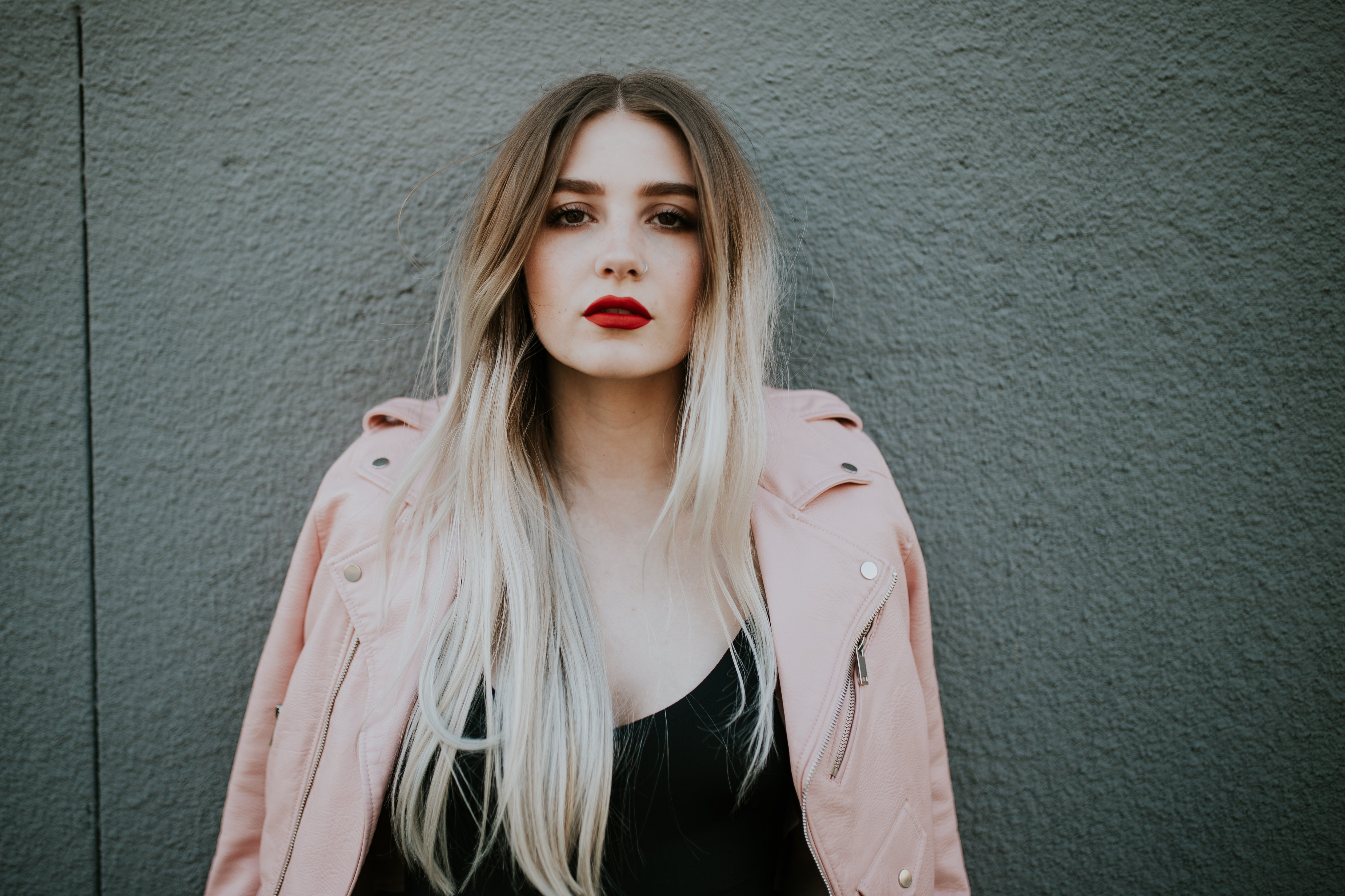 Pink Jacket Serious Grey Wall
