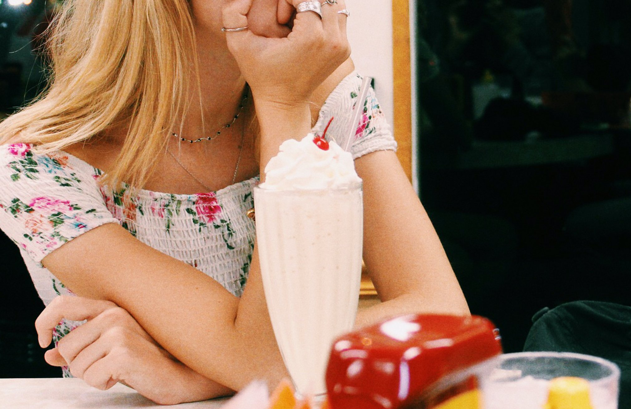 Anna Schultz girl sitting at diner with milkshake pondering?width=698&height=466&fit=crop&auto=webp&dpr=4