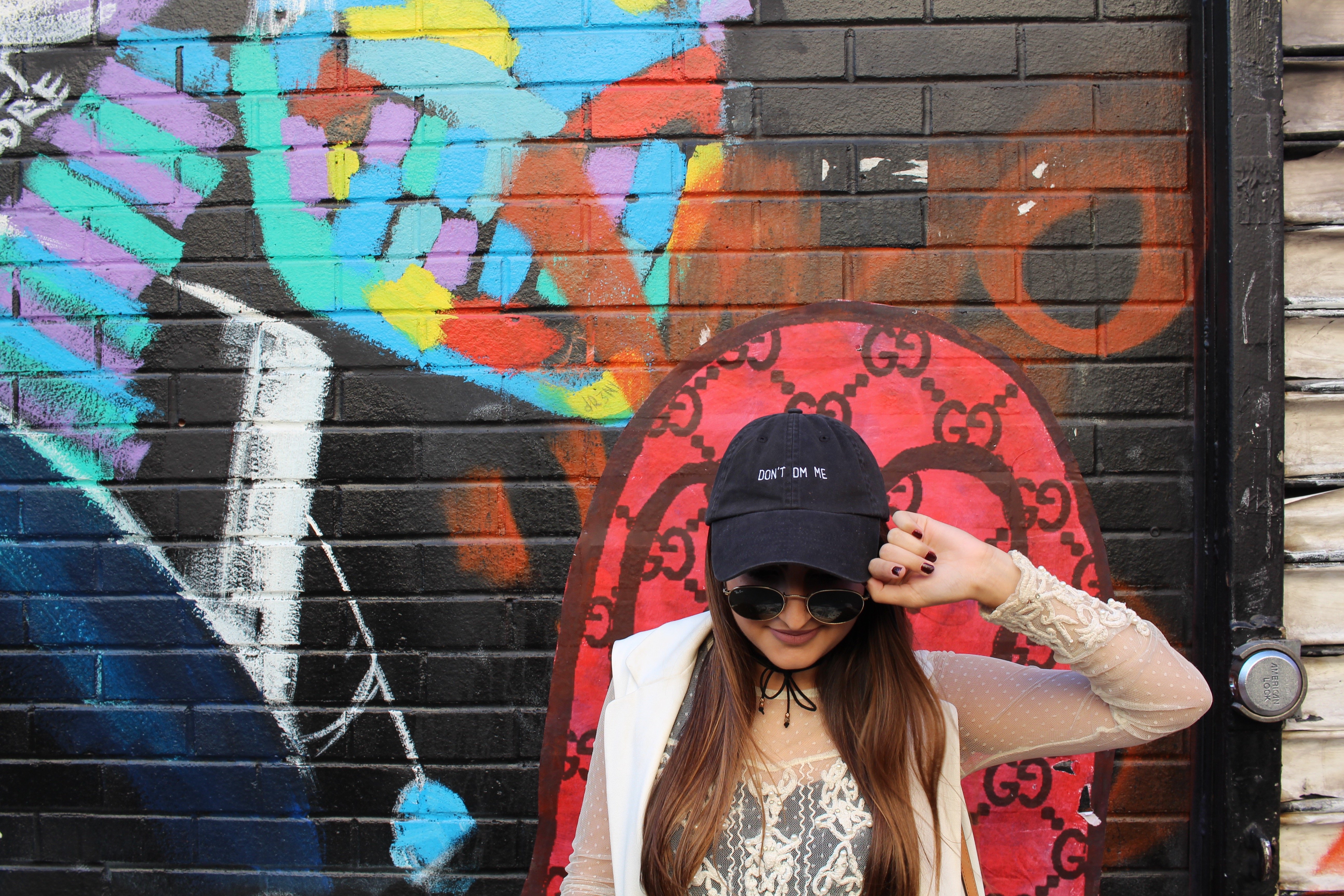 Girl In Baseball Cap Against Mural Ootd 1