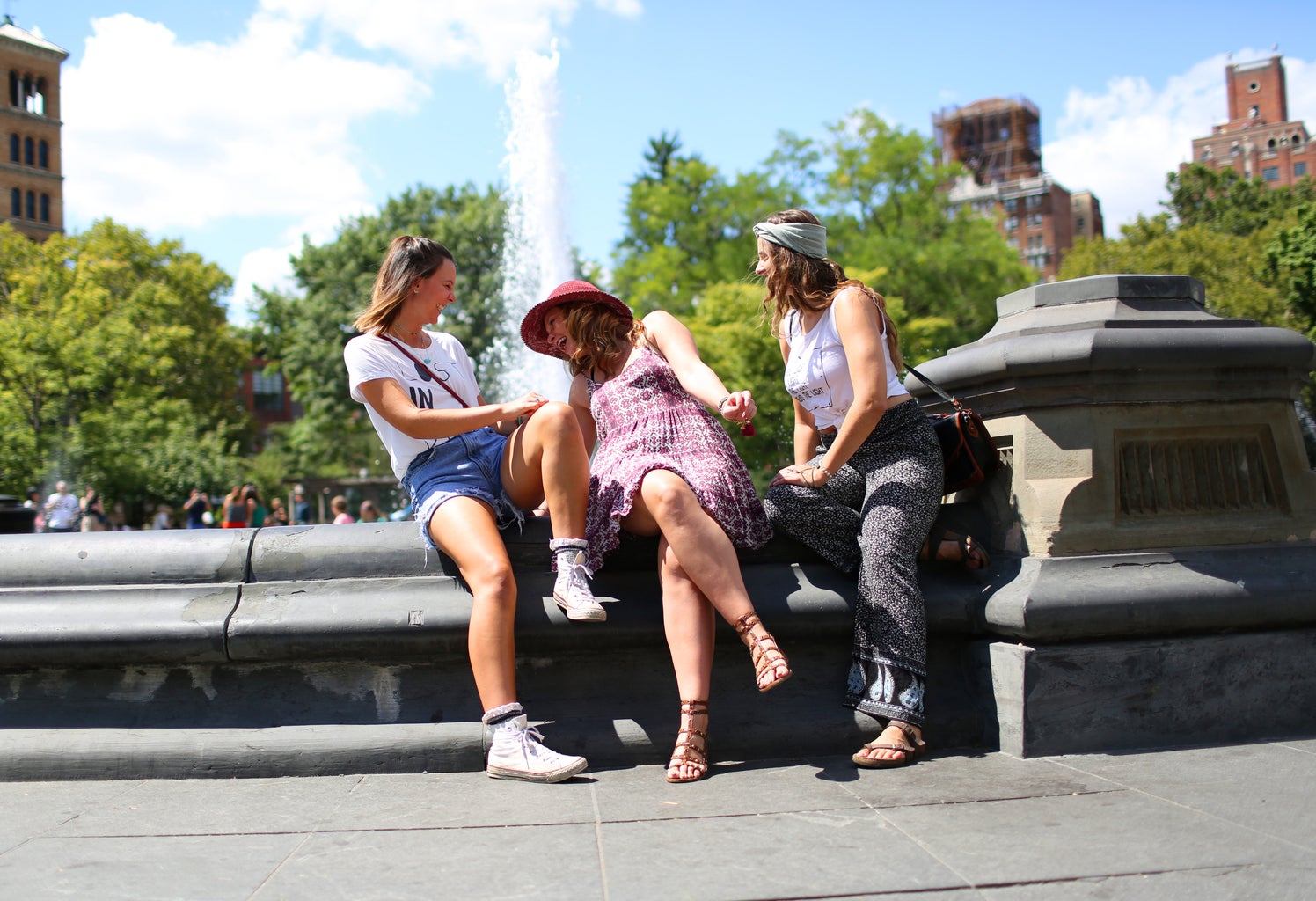 The Lalathree Girls Sitting By A Fountain