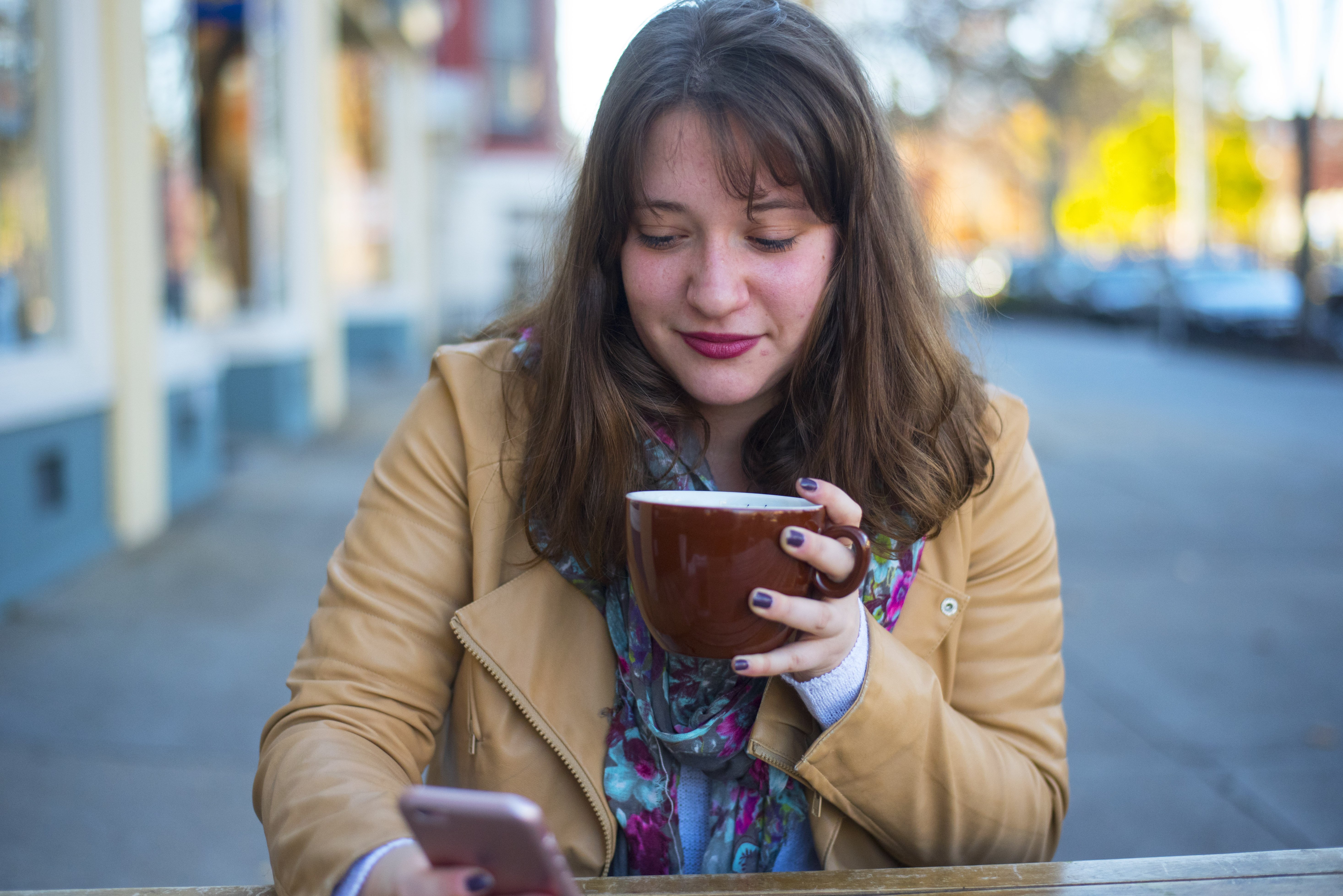 Cara Difabio girl looking at phone with coffee?width=698&height=466&fit=crop&auto=webp&dpr=4