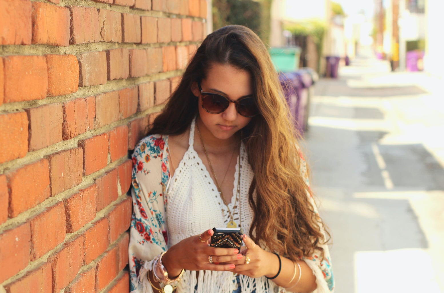 Kellyn Simpkin-Girl Next To Brick Wall Texting