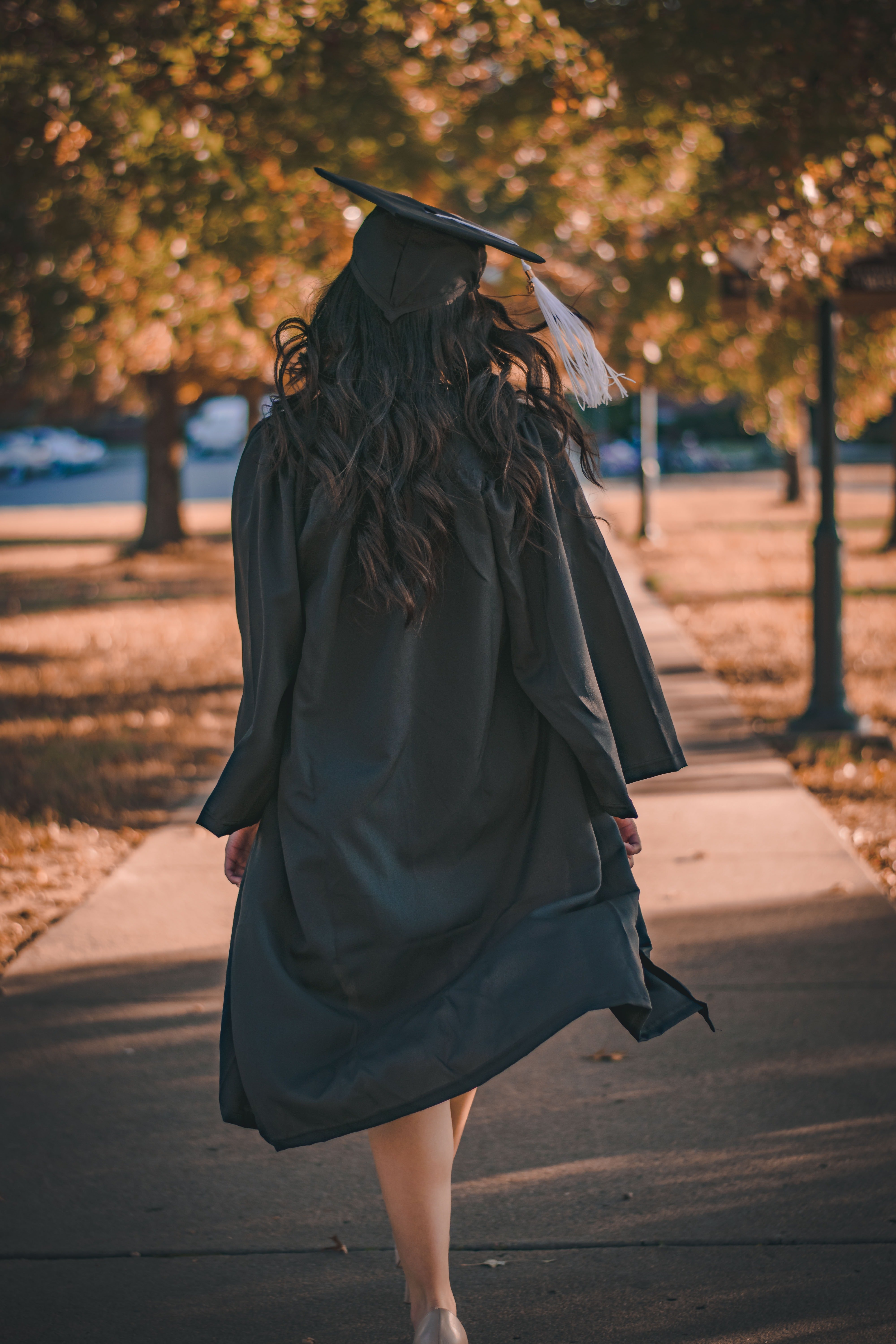 Woman In Black Long Sleeve Dress Standing On Brown Concrete