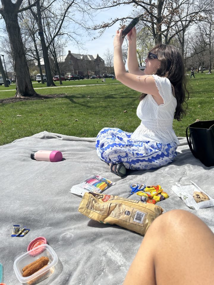 Woman taking a picture of the solar eclipse
