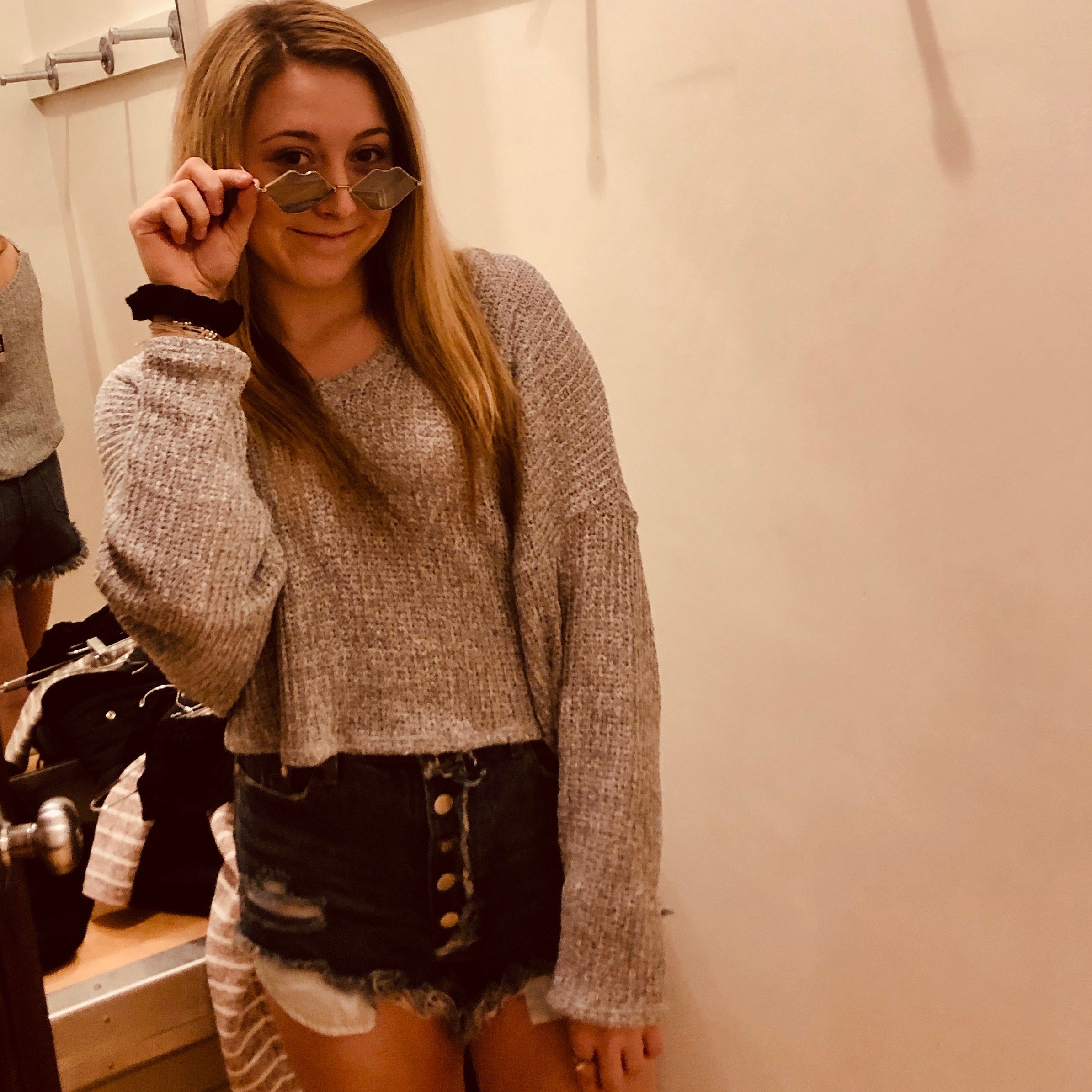 woman trying on clothes at boutique