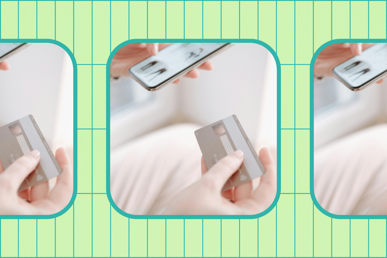 Person holding credit card and phone