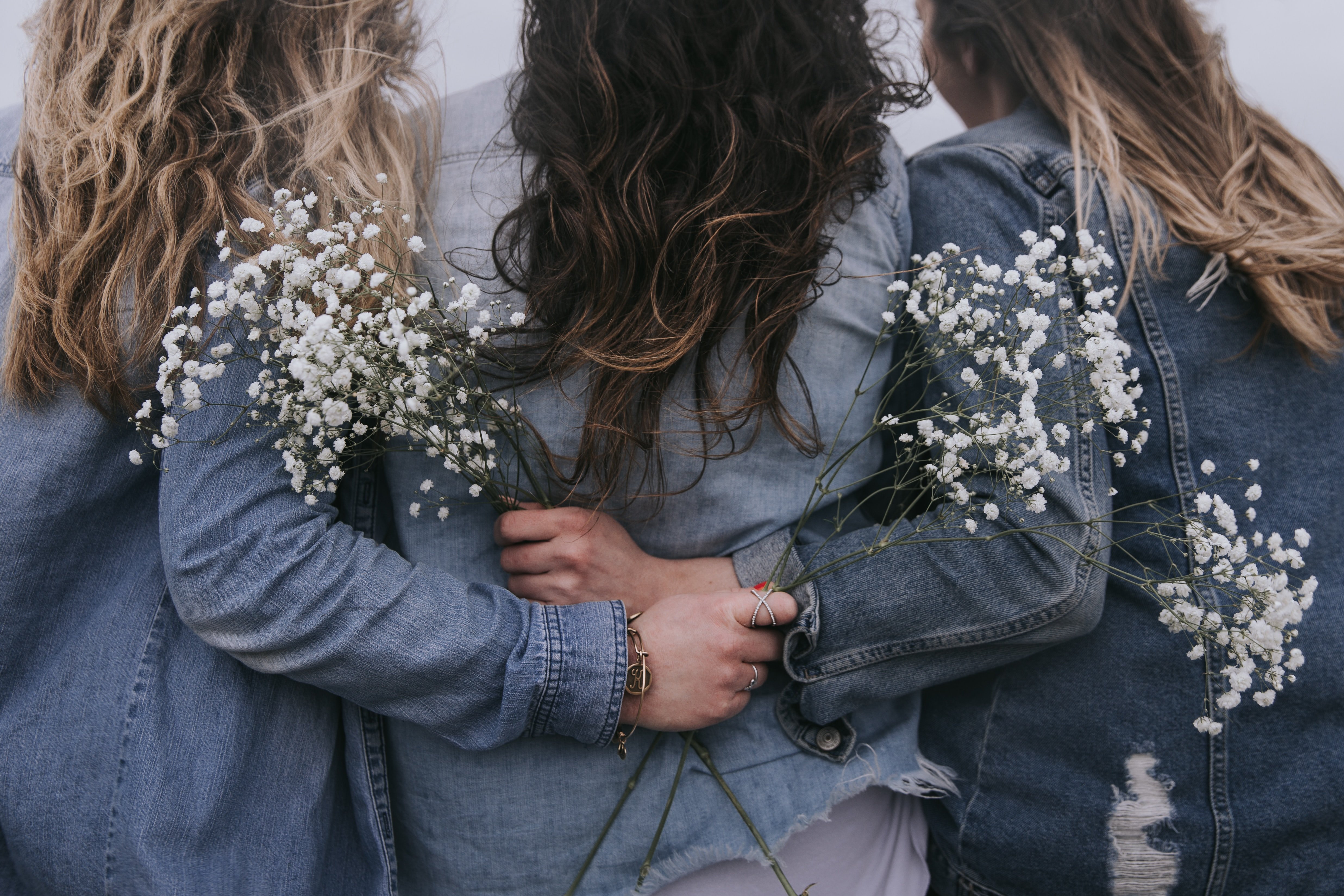 Women in jean jackets with flowers