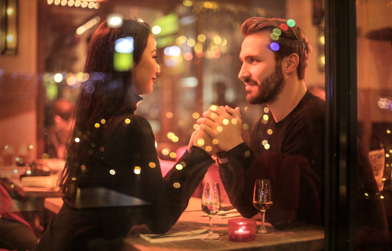 couple holding hands in a restaurant on a date